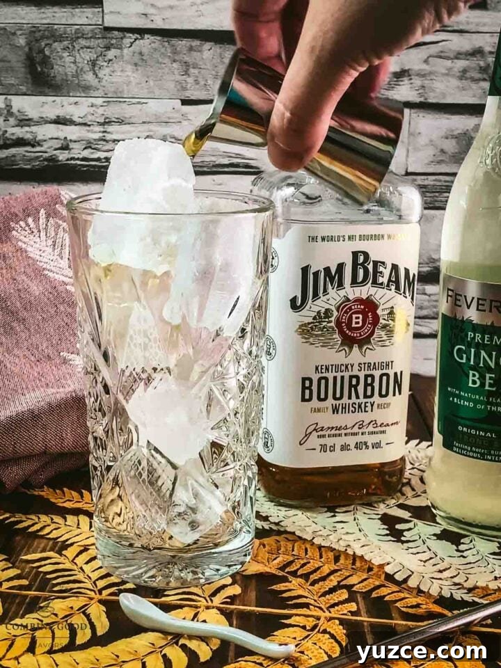 Classic Bourbon Highball Recipe: Refreshing Whiskey Cocktail Guide 5 Add Bourbon to the cubed ice filled highball glass.