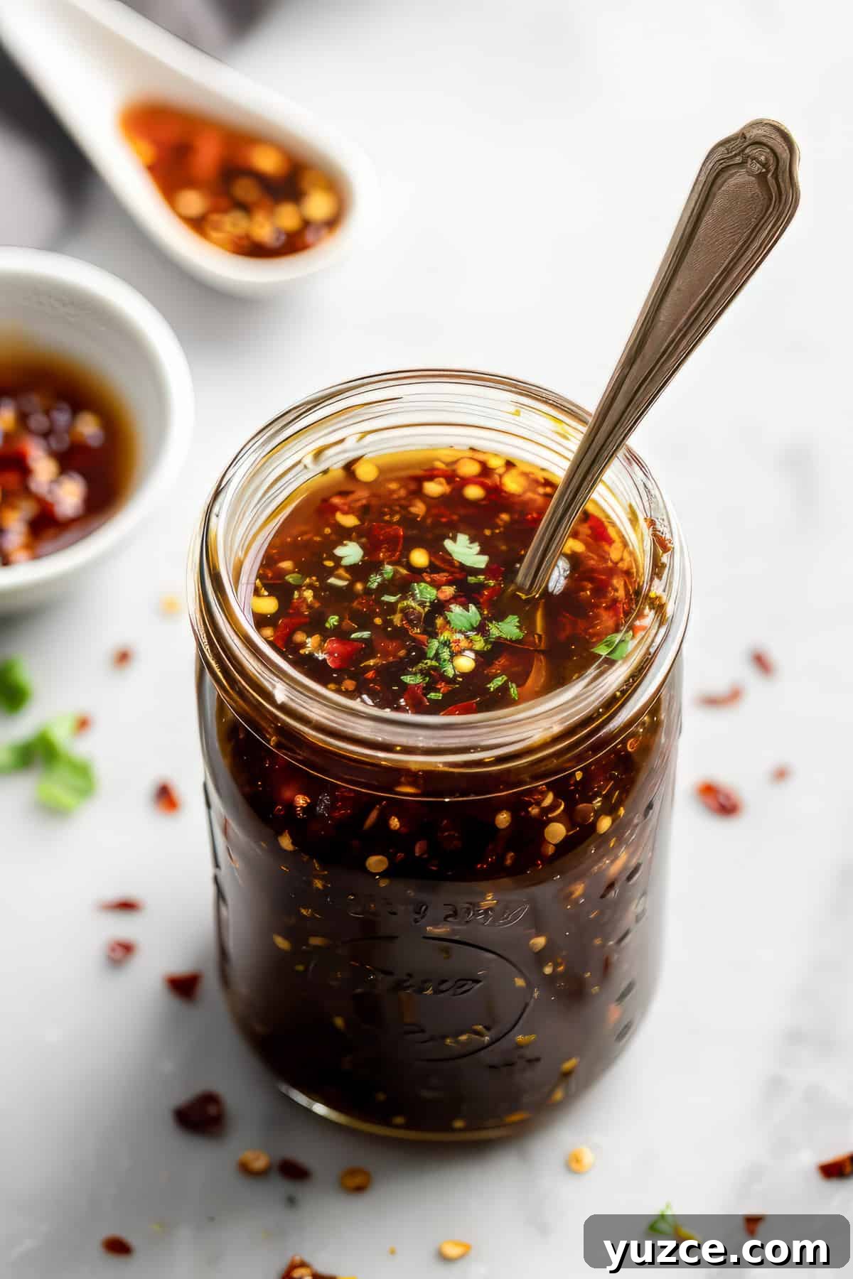 Grilled Asian Chicken Skewers with Honey Garlic Glaze 3 Homemade honey garlic sauce in a jar with a spoon.