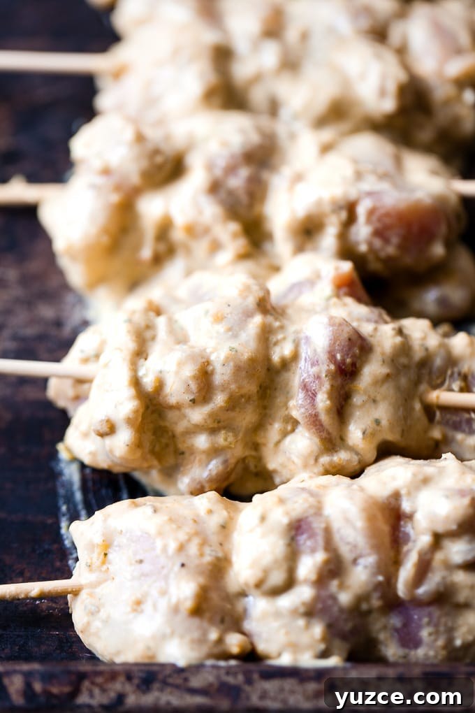 Grilled Asian Chicken Skewers with Honey Garlic Glaze 4 Thai chicken skewers on a baking tray.