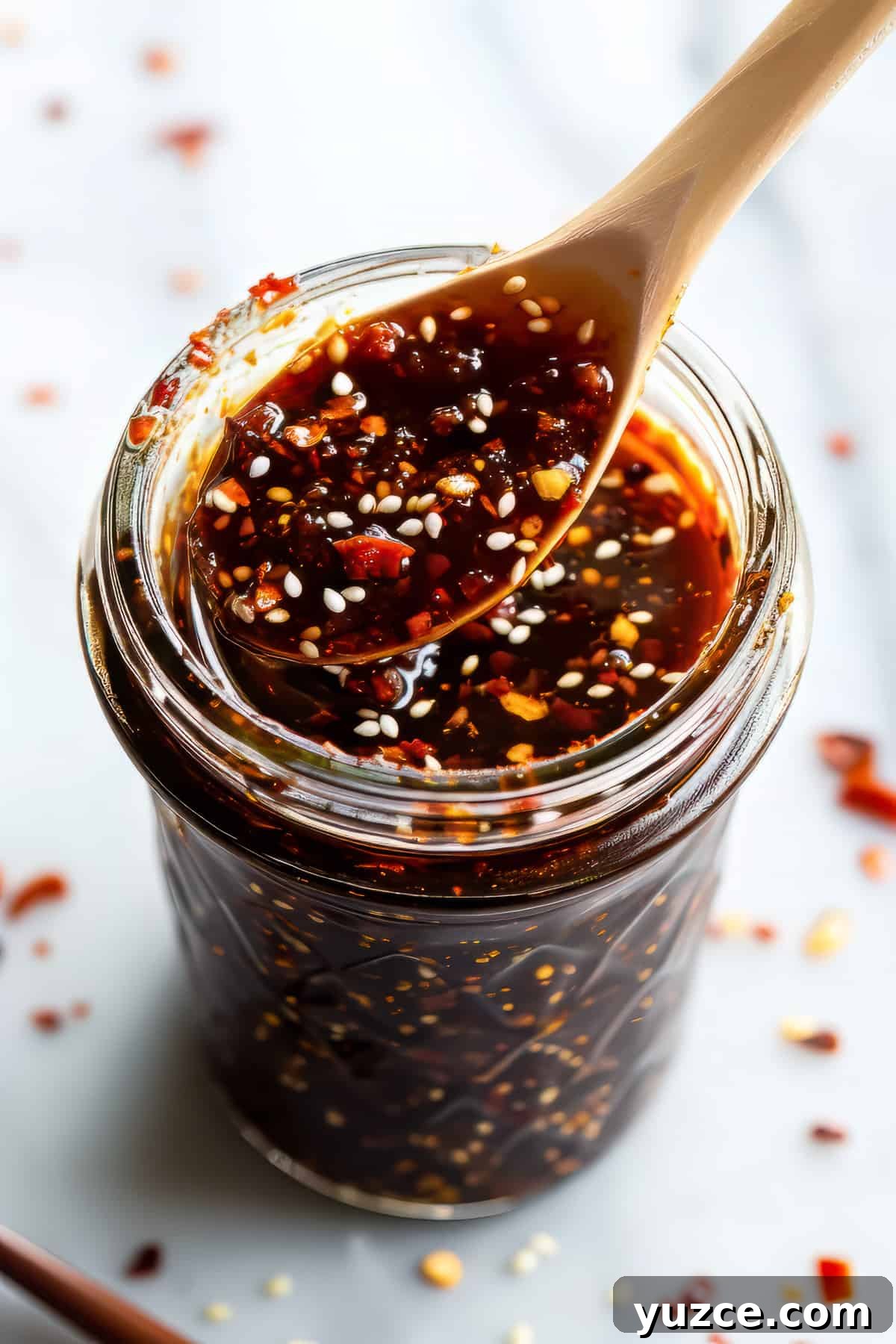 Grilled Asian Chicken Skewers with Honey Garlic Glaze 5 Homemade honey garlic sauce in a jar with a spoon.