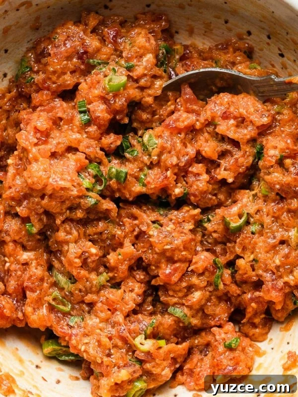 Dijon-Baked Salmon with Fresh Dill and Lemon 9 Spicy tuna with green onions in a bowl, mixed with a fork.