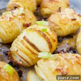Parmesan Garlic Mini Hasselback Potatoes Recipe 4 Mini parmesan and garlic hasselback potatoes on a baking tray