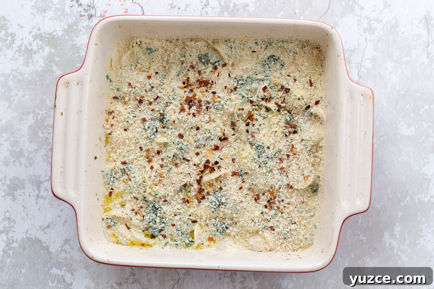 Creamy Vegan Spinach and Artichoke Pasta Bake Recipe 2 spinach artichoke pasta bake topped with breadcrumb topping ready to go in the oven