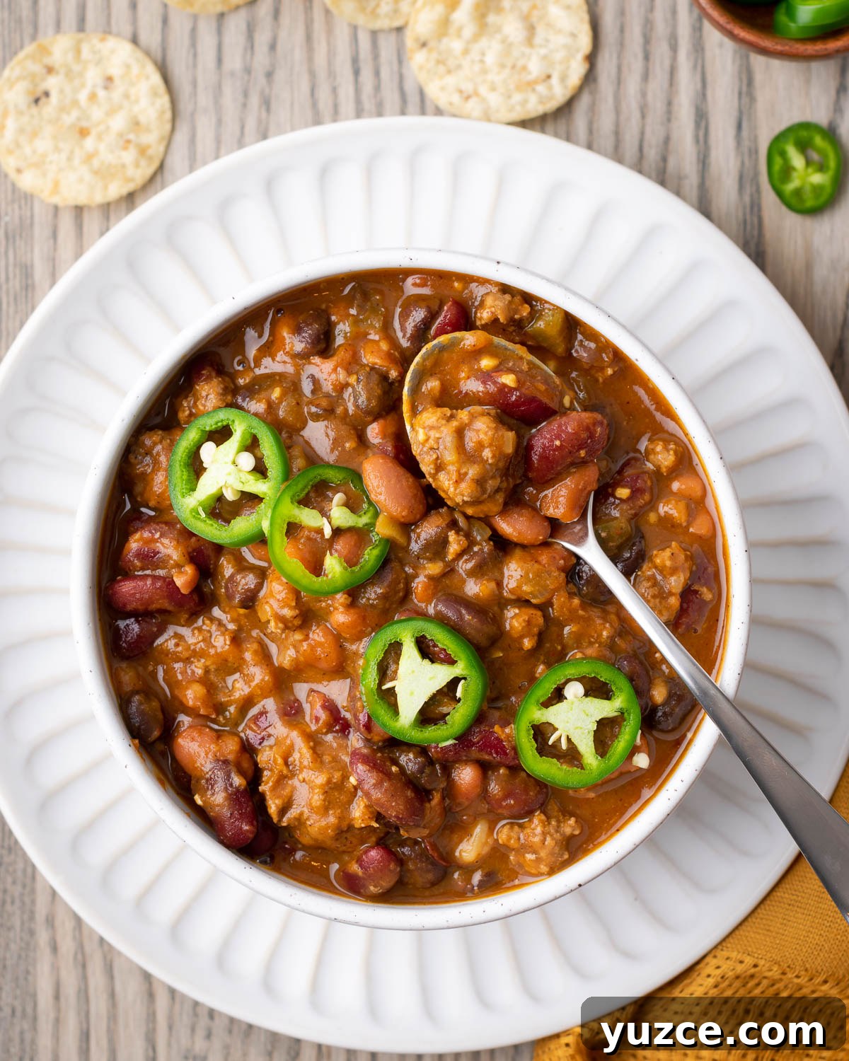 Spiced Pumpkin Chili with Turkey and Beans 2 A bowl of pumpkin chili topped with sliced jalapenos.