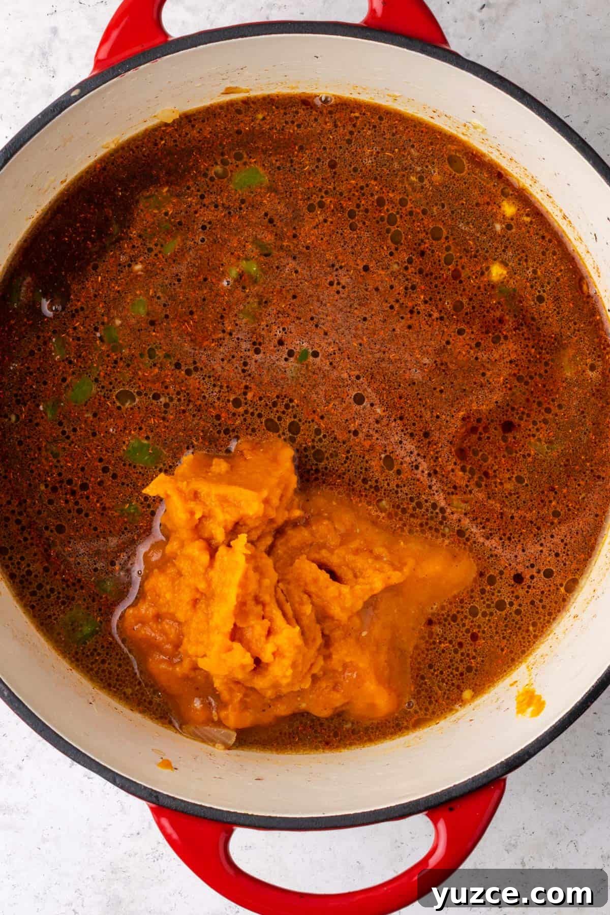 Spiced Pumpkin Chili with Turkey and Beans 6 Beef broth, pumpkin and spices being added to the soup pot.