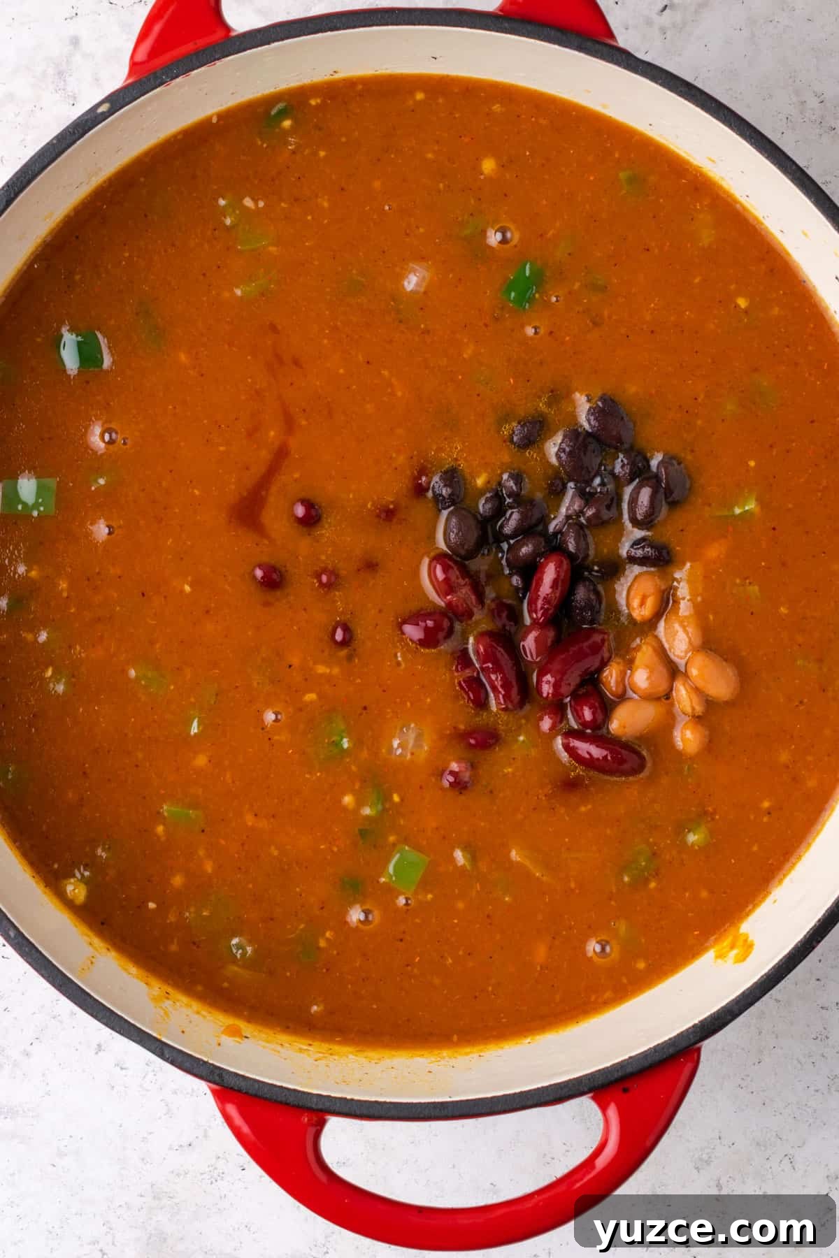 Spiced Pumpkin Chili with Turkey and Beans 7 Beans being added to the soup pot.