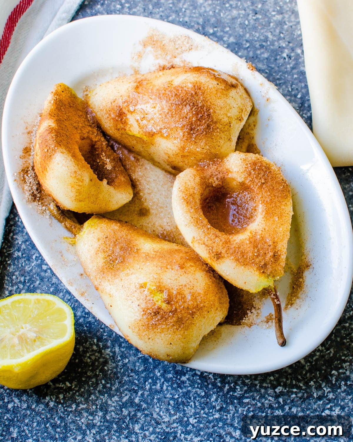 Warm Autumn-Spiced Baked Pears with Maple Glaze 3 Sliced pears being coated in lemon juice and cinnamon sugar.