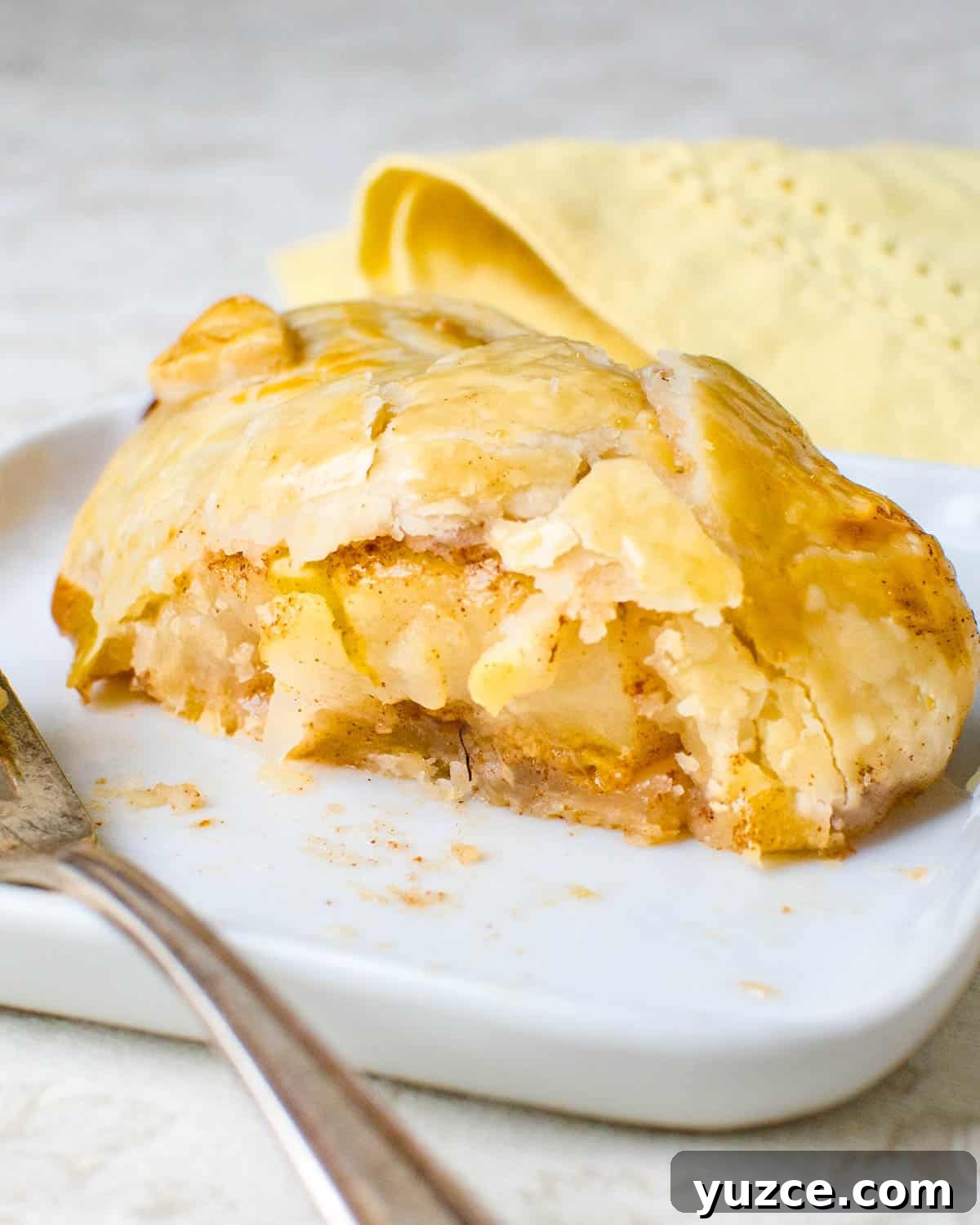 Warm Autumn-Spiced Baked Pears with Maple Glaze 8 Slicing open a baked pear so you can see the cinnamon and fruit.