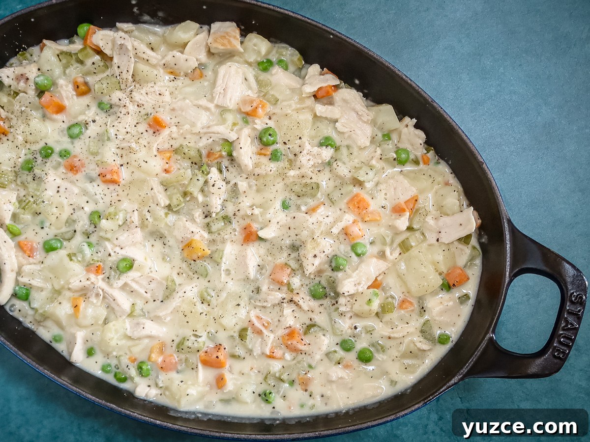 Patchwork Puff Pastry Chicken Pot Pie with Golden Crust 5 chicken pot pie filling in the baking dish.