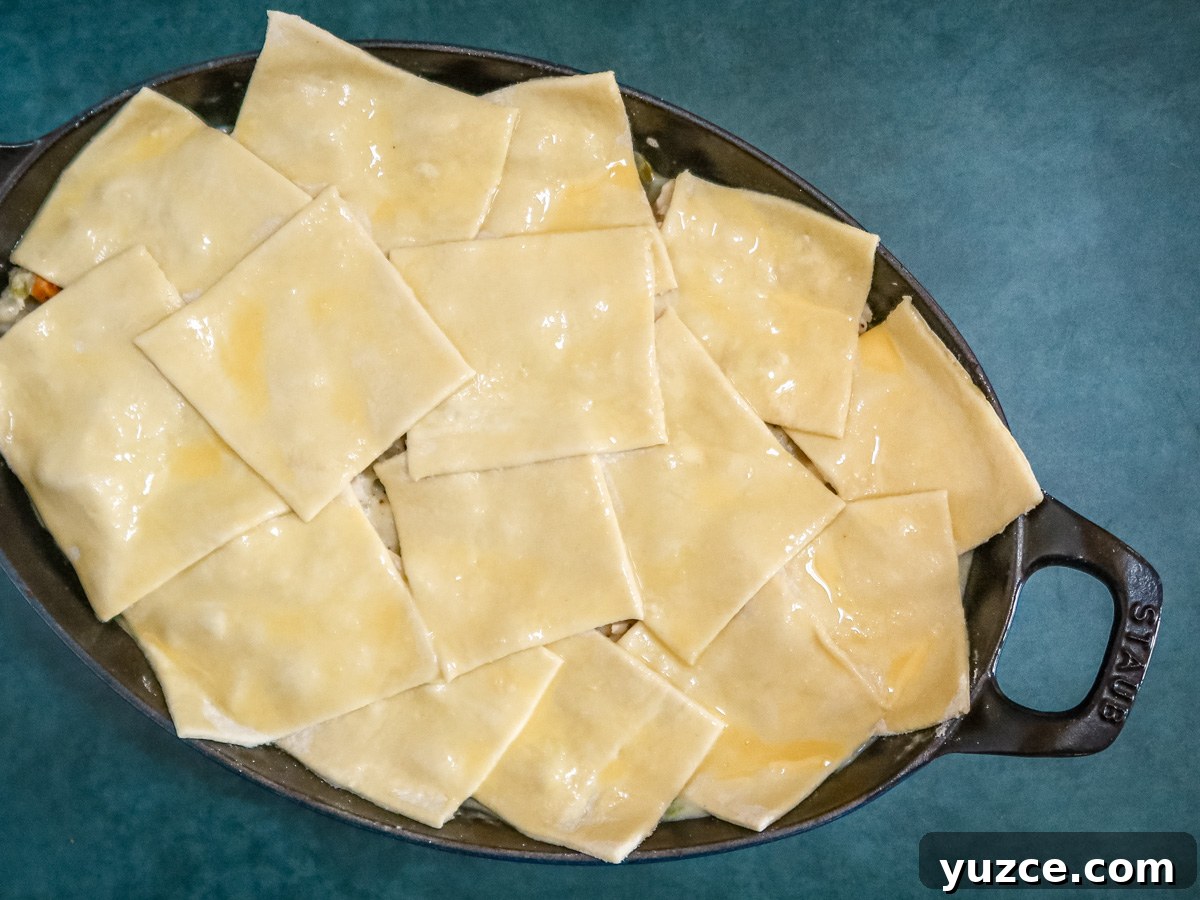 Patchwork Puff Pastry Chicken Pot Pie with Golden Crust 6 chicken pot pie covered with squares of puff pastry, ready to bake.