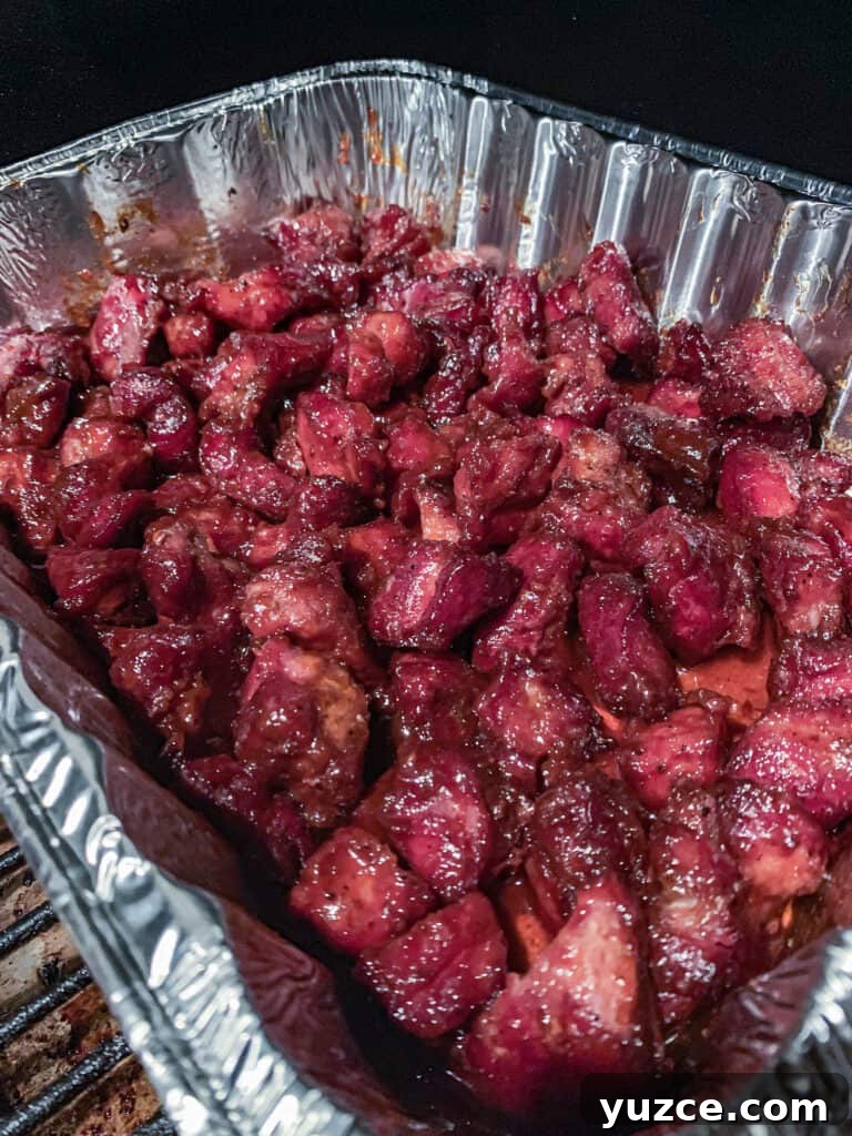 Smoky Pork Shoulder Burnt Ends Recipe for Tender, Crispy Bites 6 Pork Shoulder chunks after they've been cooking for about 7 hours
