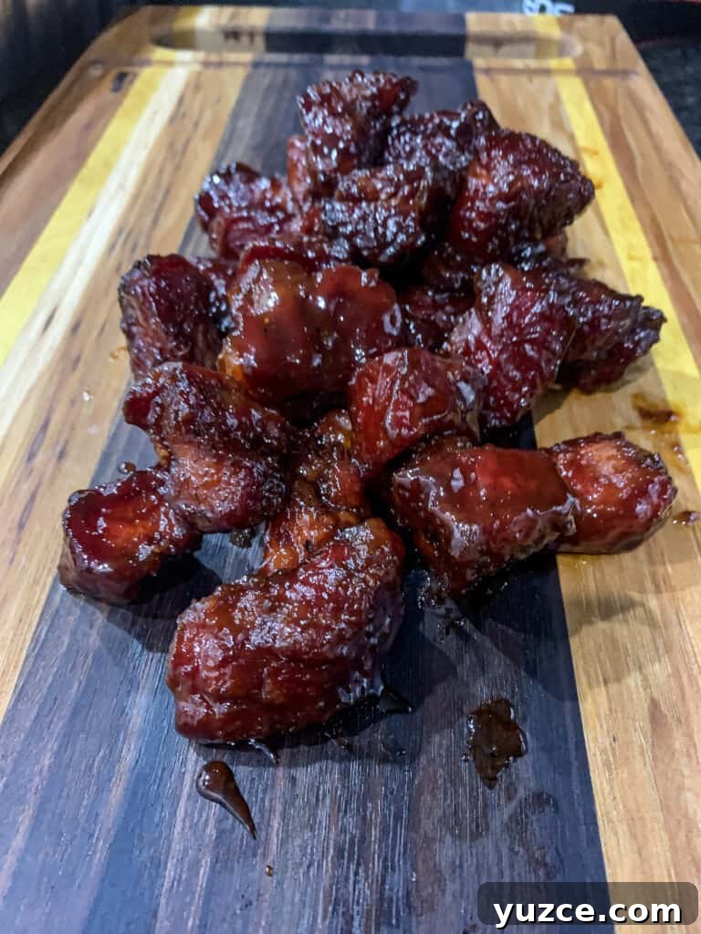 Smoky Pork Shoulder Burnt Ends Recipe for Tender, Crispy Bites 7 Pork Shoulder Burnt Ends on a cutting board