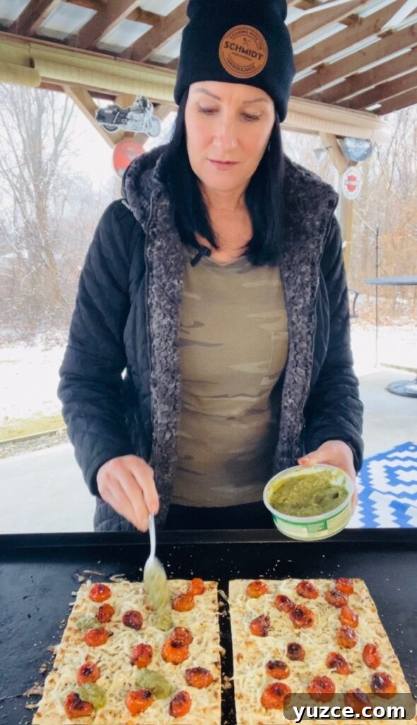 adding pesto to Blackstone pizzas