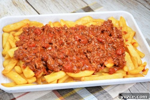 Chili Cheese Fries Recipe: Loaded Fries with Spicy Beef and Melted Cheese 3 homemade french fries topped with chili with beef.
