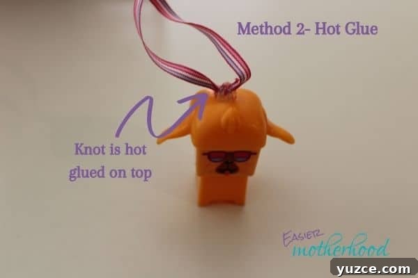Image illustrating how to turn a toy into a Christmas ornament using the hot glue method- finished toy has arrow showing the hot glue and knot sitting on top of the toy.