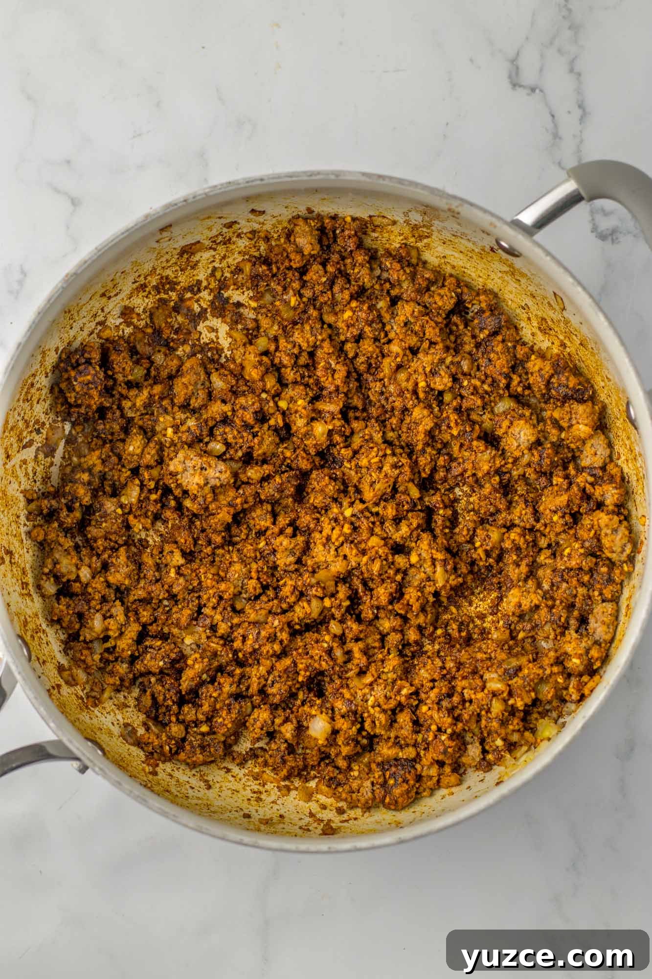 Creamy Cornbread Casserole with Cheesy Corn Topping 4 Sauteed ground beef in a skillet with seasonings