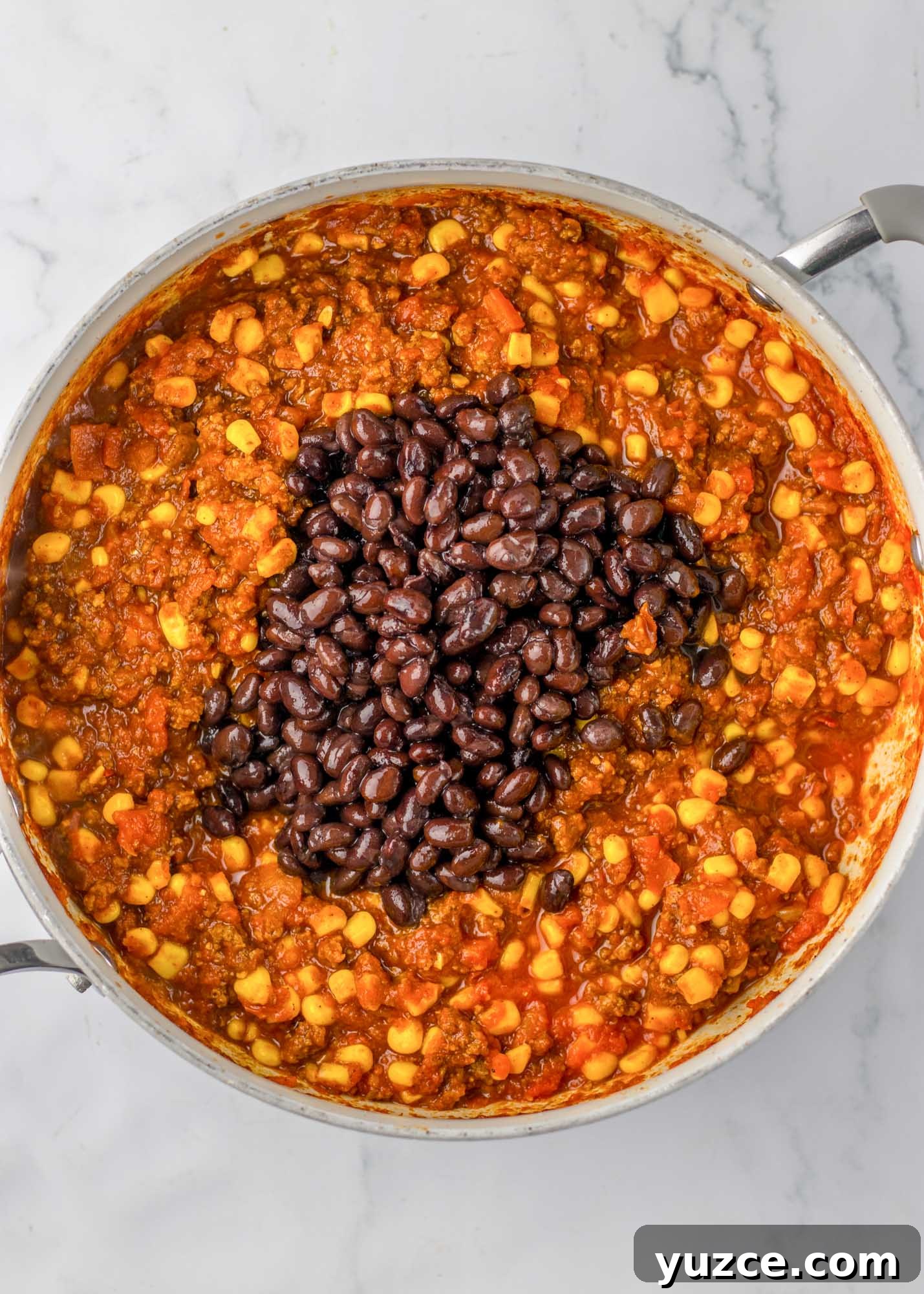 Creamy Cornbread Casserole with Cheesy Corn Topping 6 Added beans to the chili in a skillet
