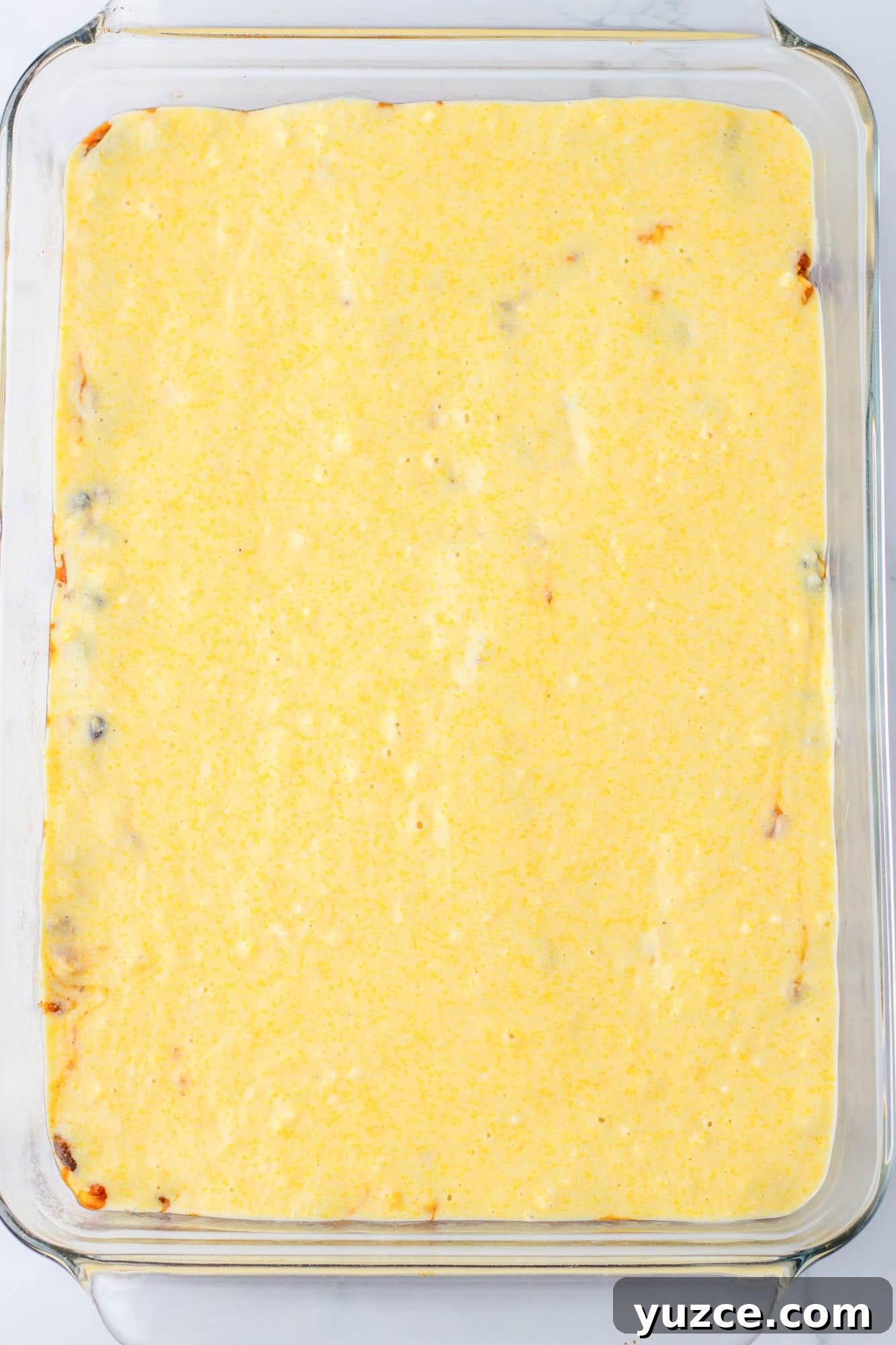 Creamy Cornbread Casserole with Cheesy Corn Topping 8 Spreaded cornbread batter on a casserole