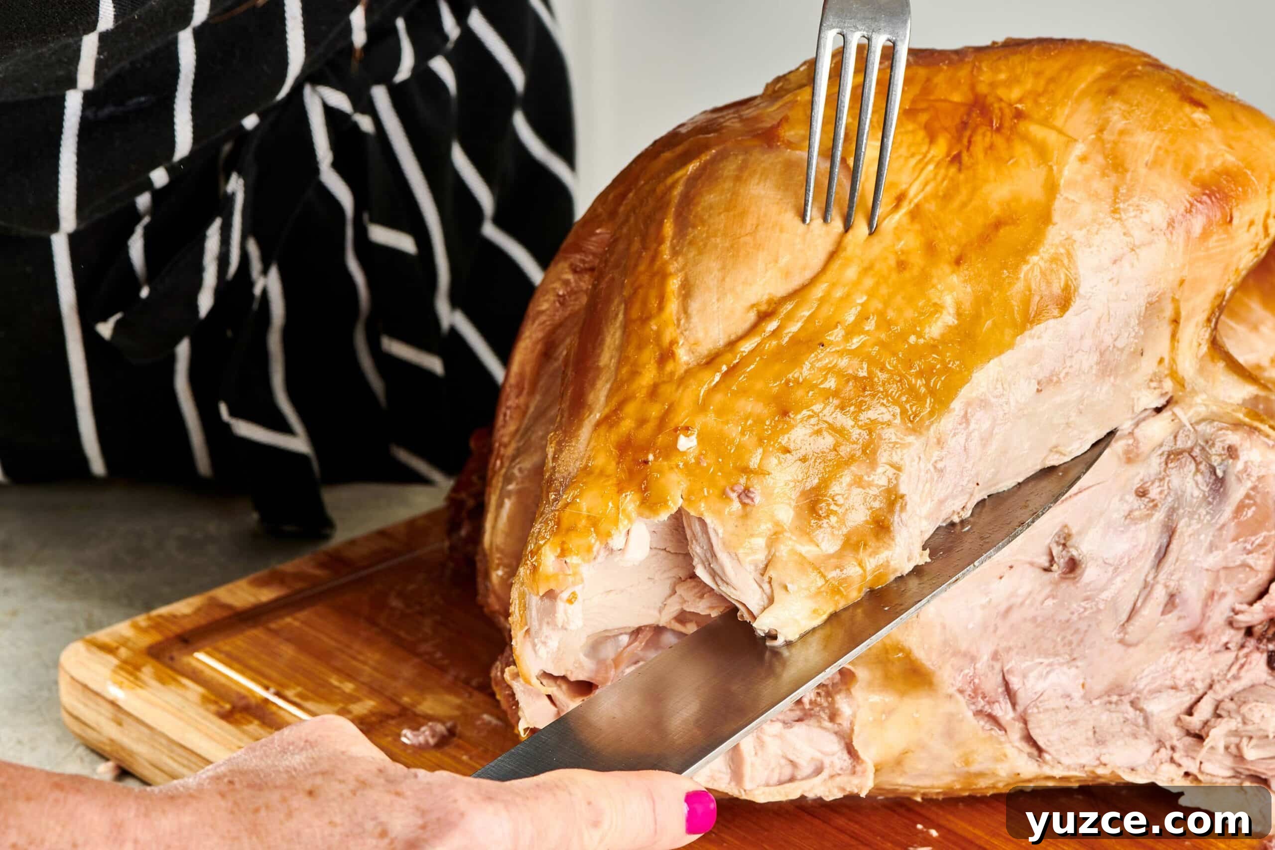 Perfect Turkey Carving Guide: Step-by-Step Tips for Juicy Slices 7 Woman removing turkey breast from a roast turkey.
