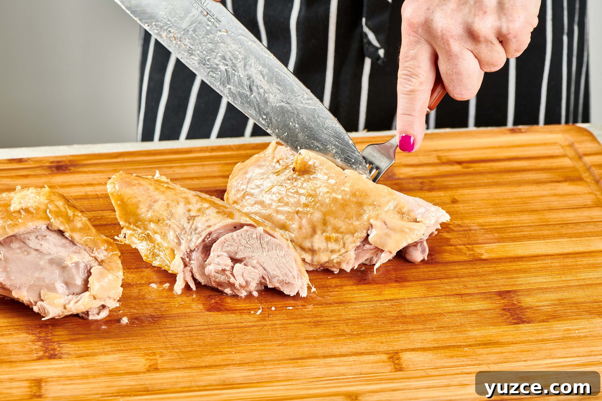 Perfect Turkey Carving Guide: Step-by-Step Tips for Juicy Slices 9 Woman carving turkey thigh.