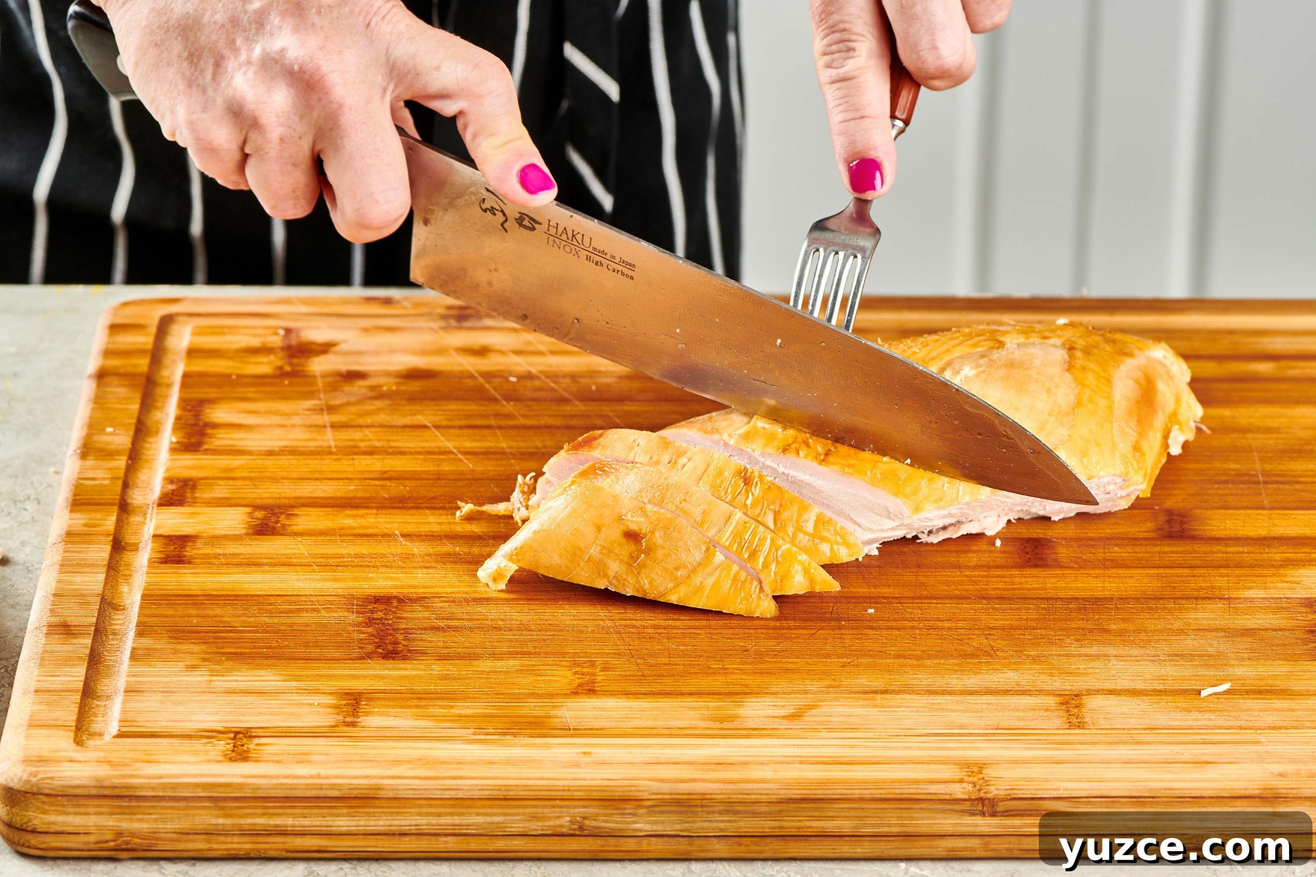Perfect Turkey Carving Guide: Step-by-Step Tips for Juicy Slices 10 Woman slicing turkey breast.