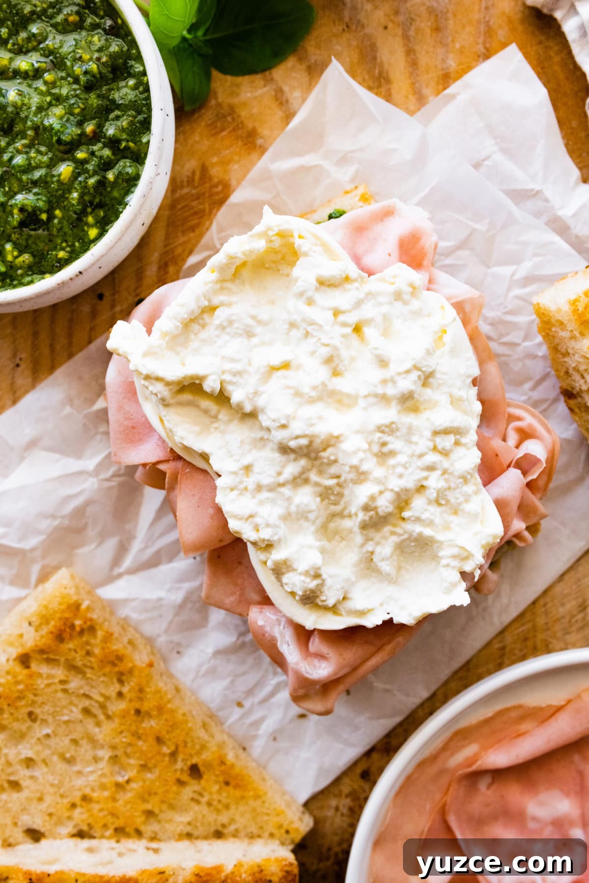 Classic Italian Mortadella Sandwich Recipe — Quick Lunch Idea 11 How to make Mortadella Sandwich Recipe with Pistachio Pesto and Burrata (step-by-step): adding the burrata on top of the mortadella.