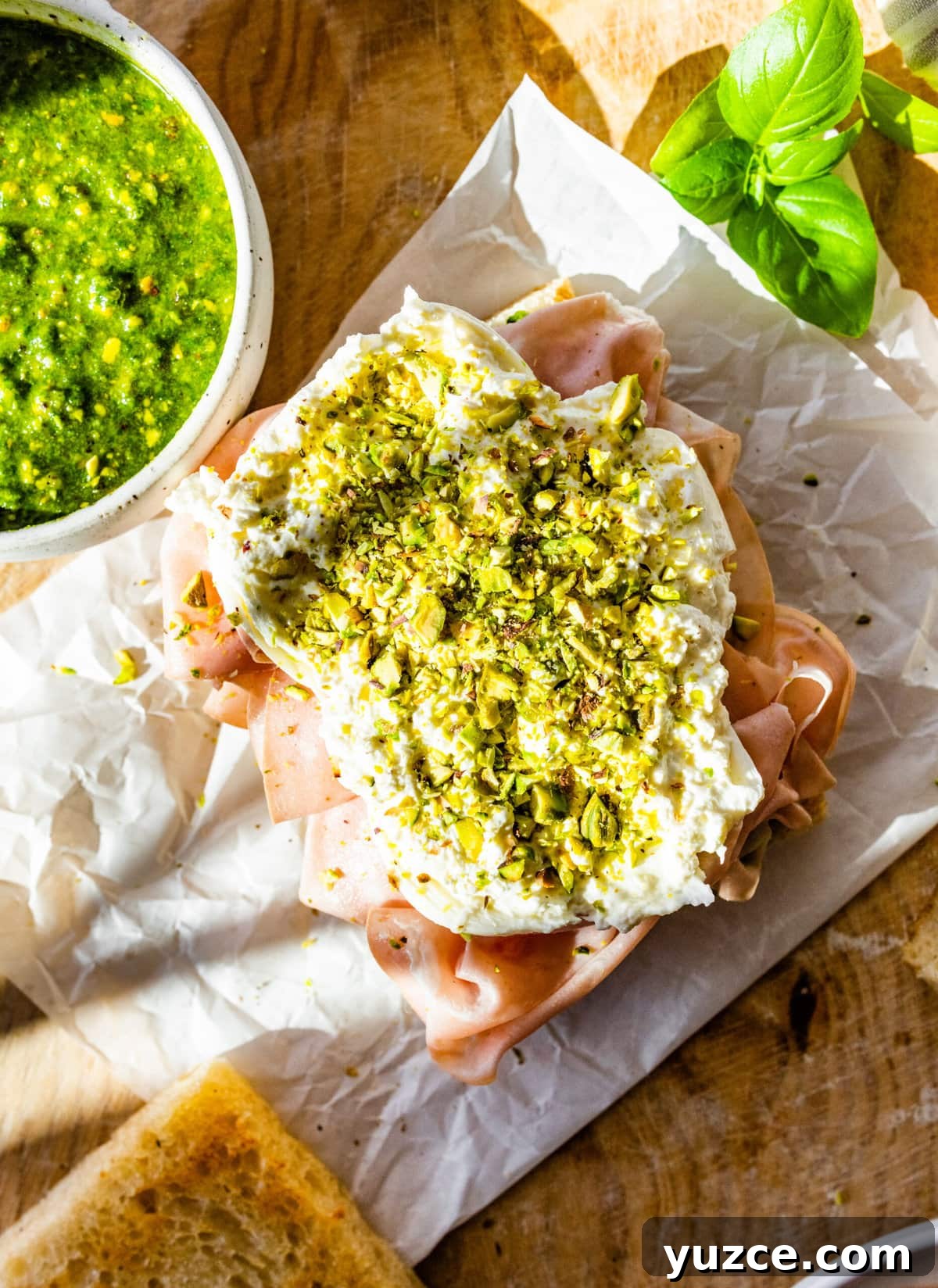 Classic Italian Mortadella Sandwich Recipe — Quick Lunch Idea 13 How to make Mortadella Sandwich Recipe with Pistachio Pesto and Burrata (step-by-step): adding crushed pistachios on top of the burrata cheese.