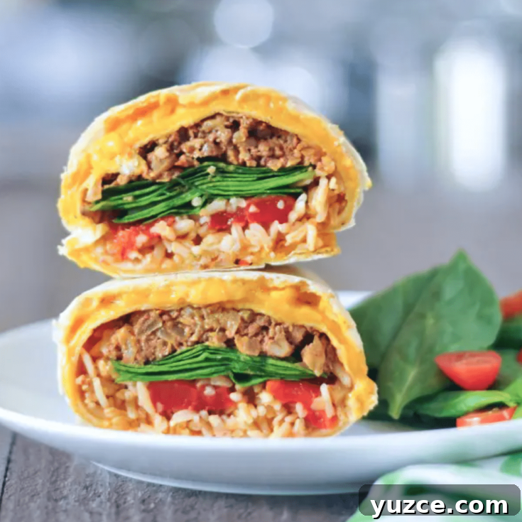 a cheesy quesarito sliced in half and stacked to show insides - rice, beans, spinach, and tomato salsa wrapped in a cheese layer of quesadilla.