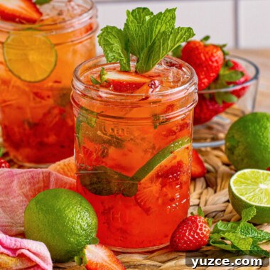 Strawberry Vodka Smash: Refreshing Summer Cocktail Recipe 11 square image of two strawberry vodka smash cocktails garnished with strawberries and mint