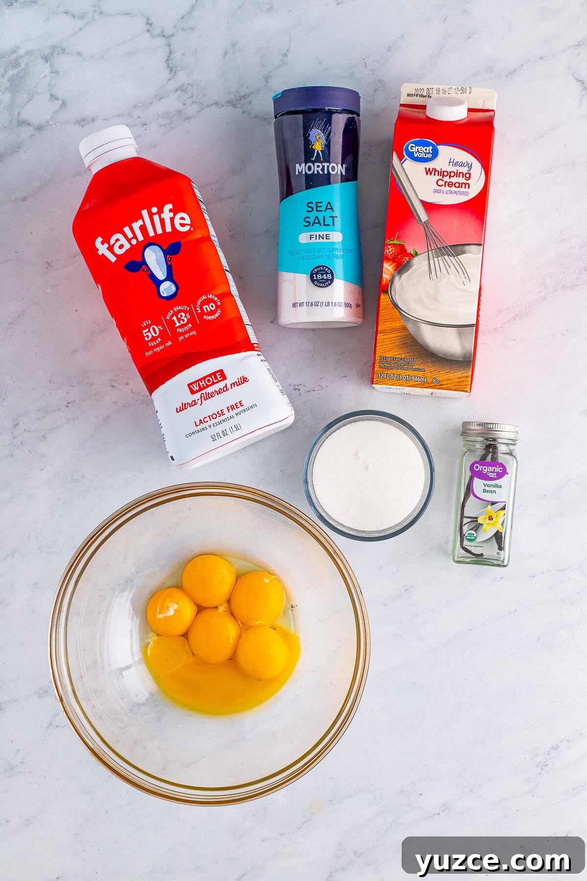 Overhead shot showing ingredients needed to make Creme Anglaise Recipe on a grey marble table top.