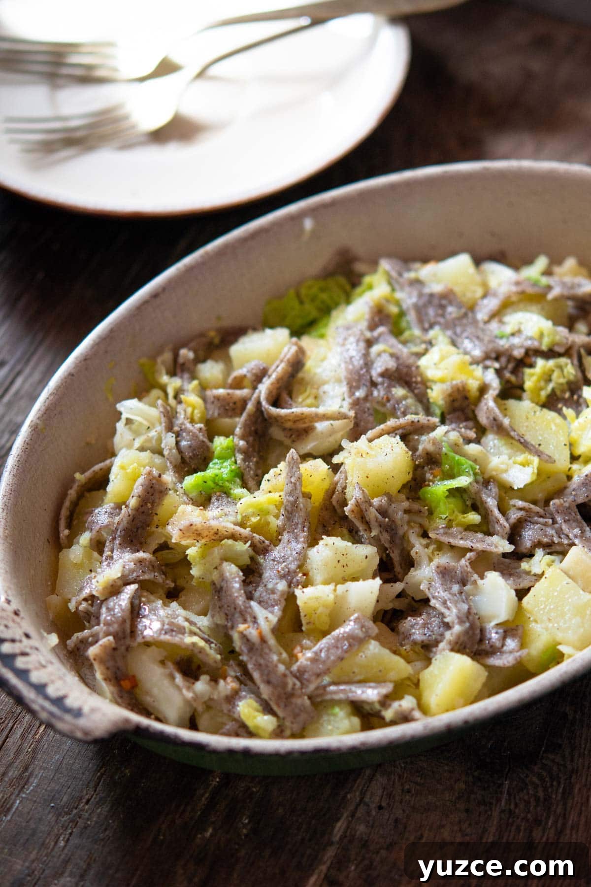 PIzzoccheri pasta in a baking dish with potatoes, cabbage and fontina cheese