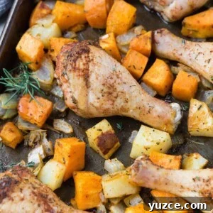 Herb-Roasted Chicken Drumsticks with Crispy Potatoes 8 Chicken drumsticks and cubed potatoes and sweet potatoes on a sheet pan.