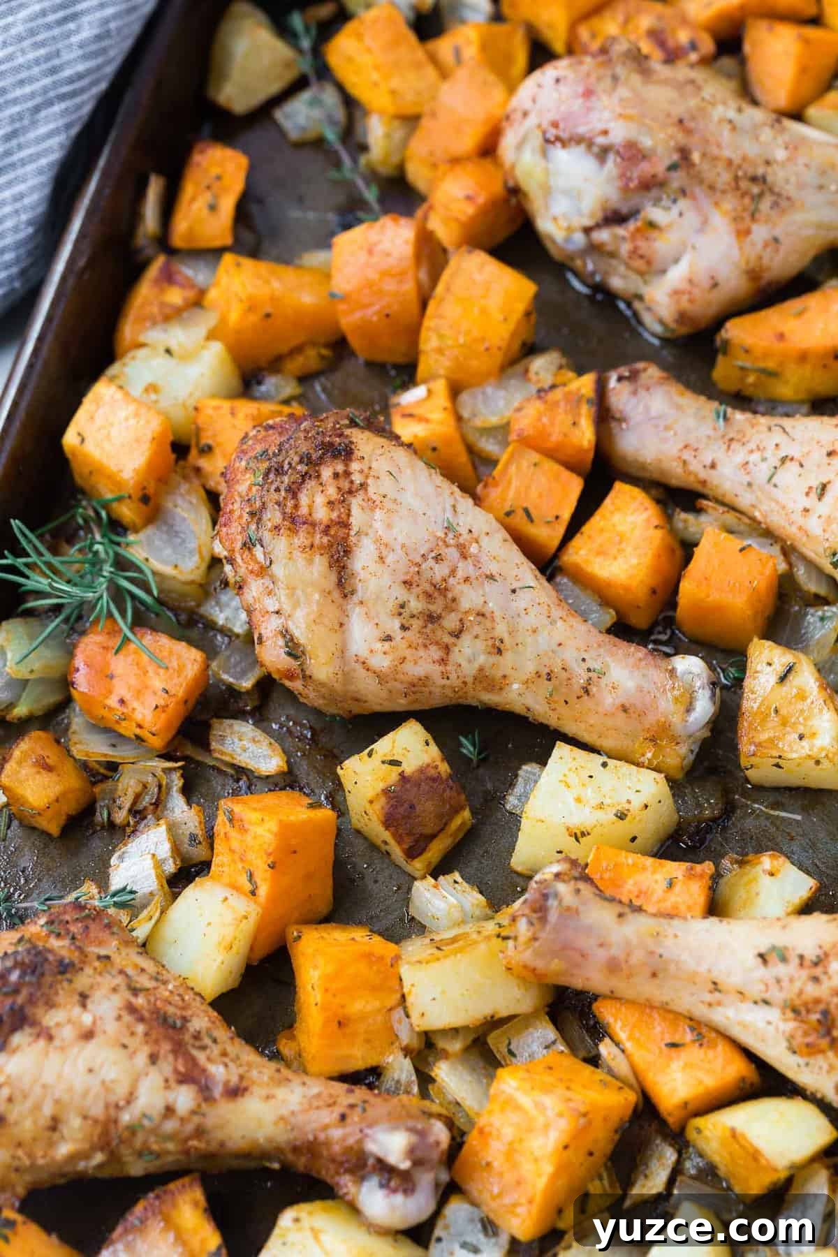Herb-Roasted Chicken Drumsticks with Crispy Potatoes 5 Roasted potatoes and drumsticks on a sheet pan.