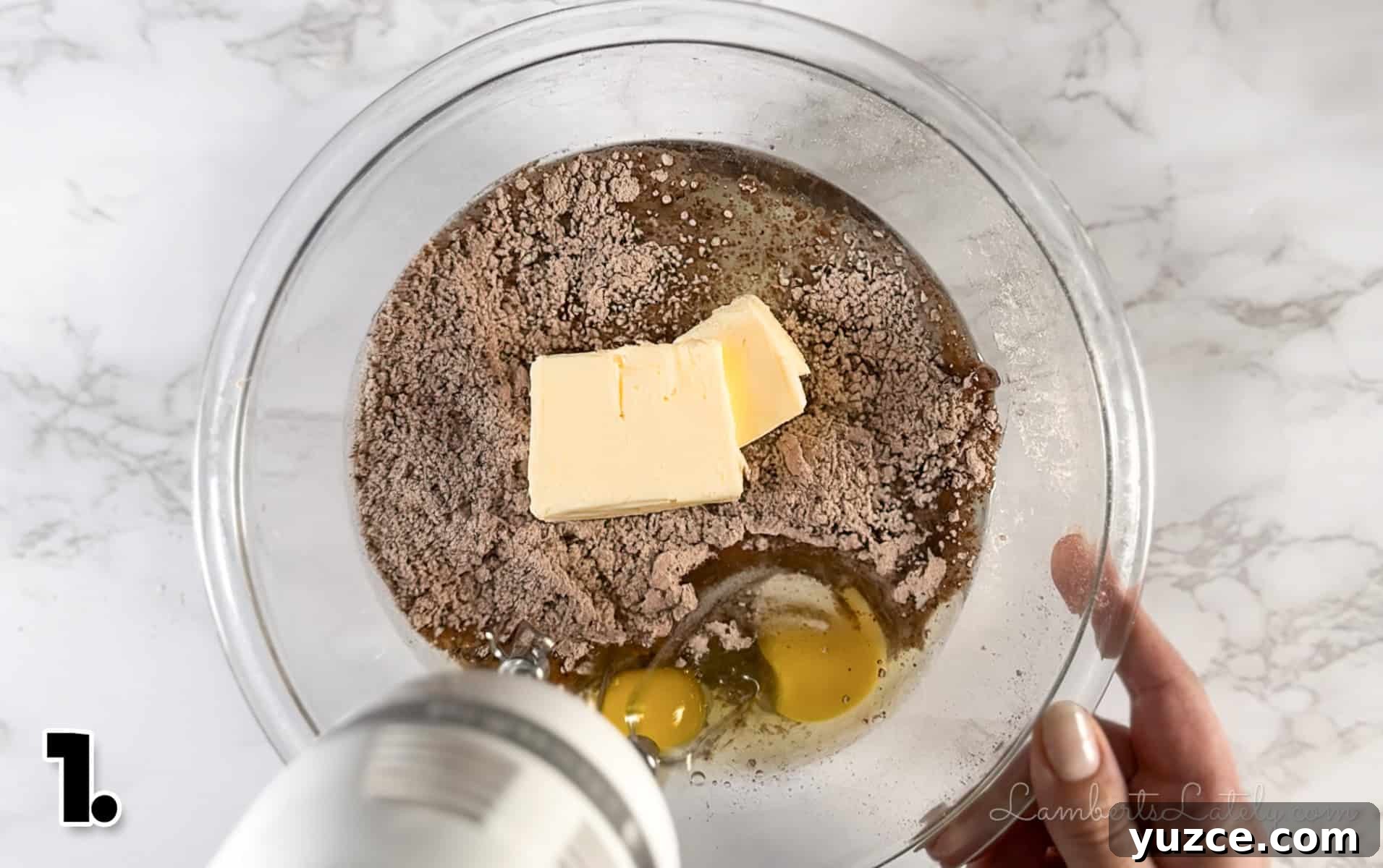 Decadent Rocky Road Cookies with Chocolate, Nuts & Marshmallows 4 mixing butter, eggs, and brownie mix in a bowl.
