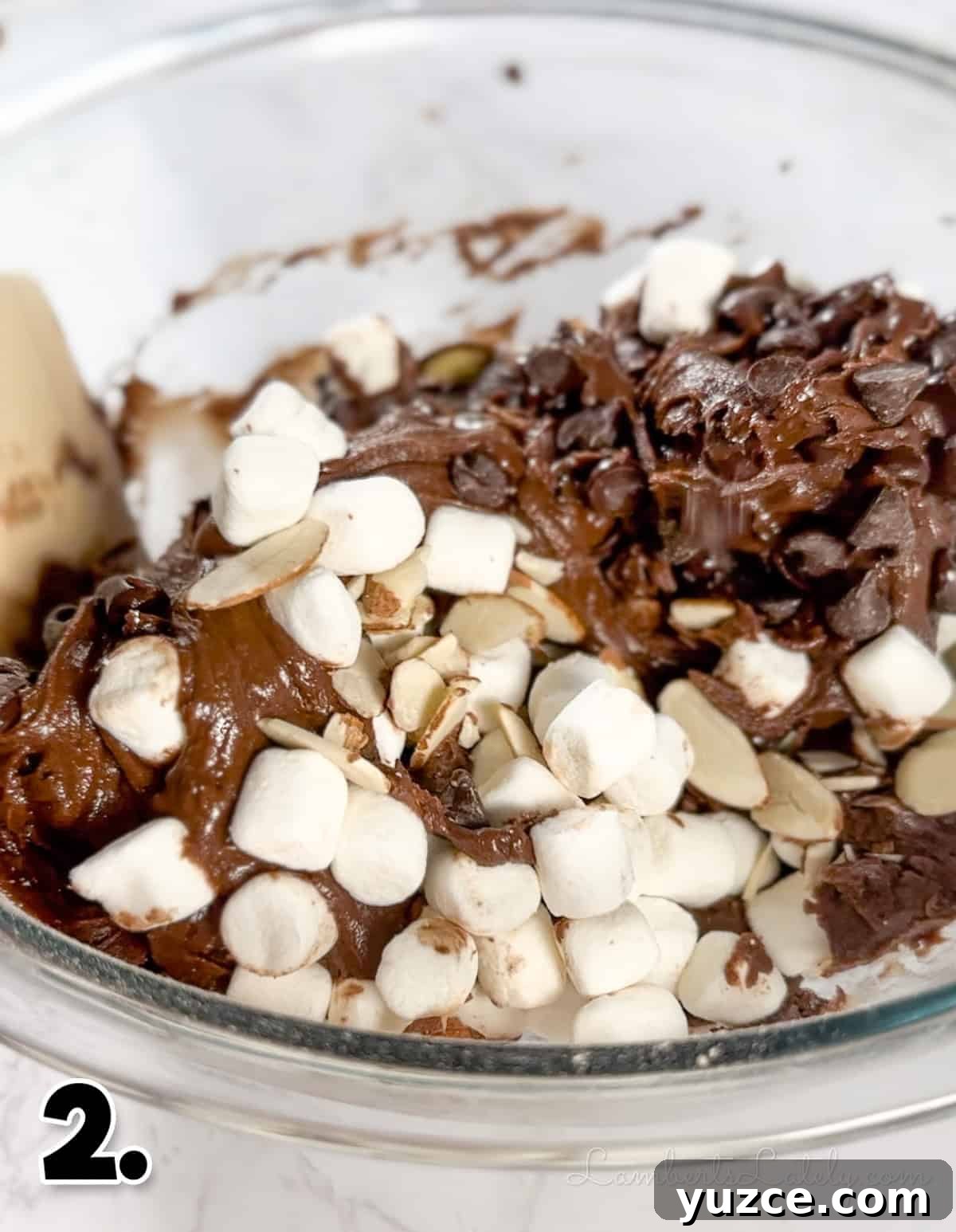 Decadent Rocky Road Cookies with Chocolate, Nuts & Marshmallows 5 folding in marshmallows, chocolate chips, and almonds into brownie mix.