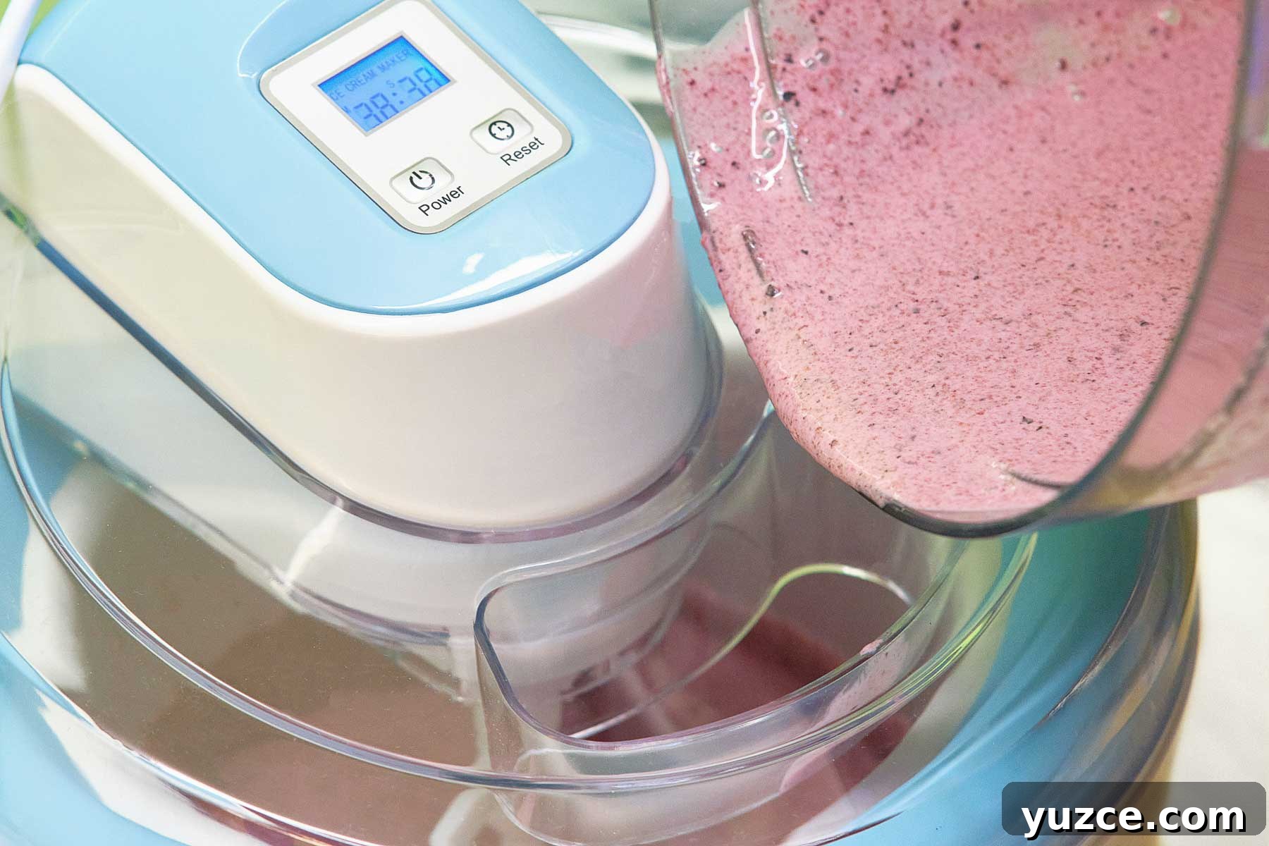 Blueberry Sherbet Recipe: Refreshing Homemade Frozen Treat 7 Pouring blueberry sorbet into an ice cream maker.