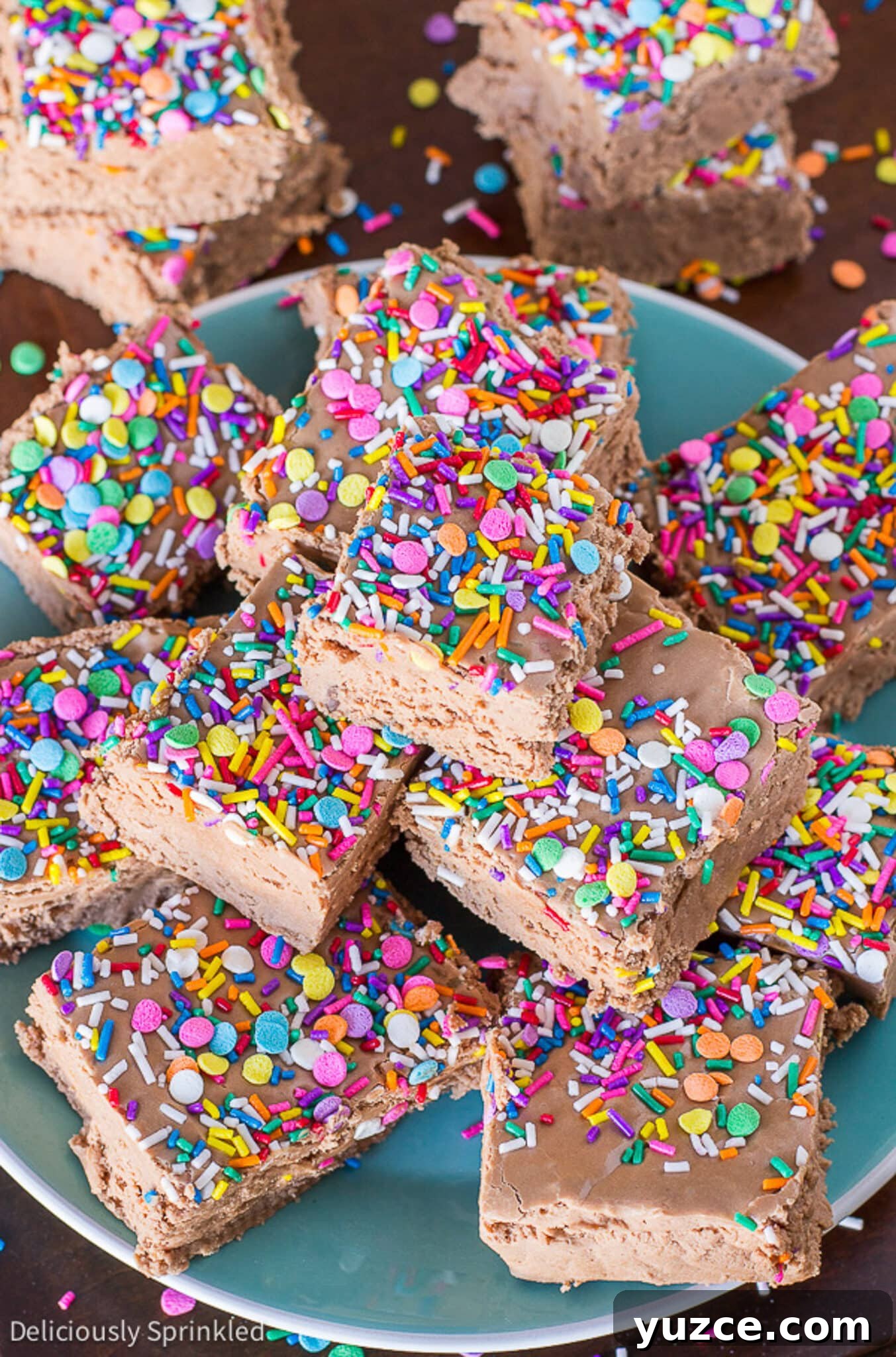 Creamy Marshmallow Fudge Recipe: Soft, No-Bake Treat 5 fantasy fudge stacked on a plate with sprinkles on top.