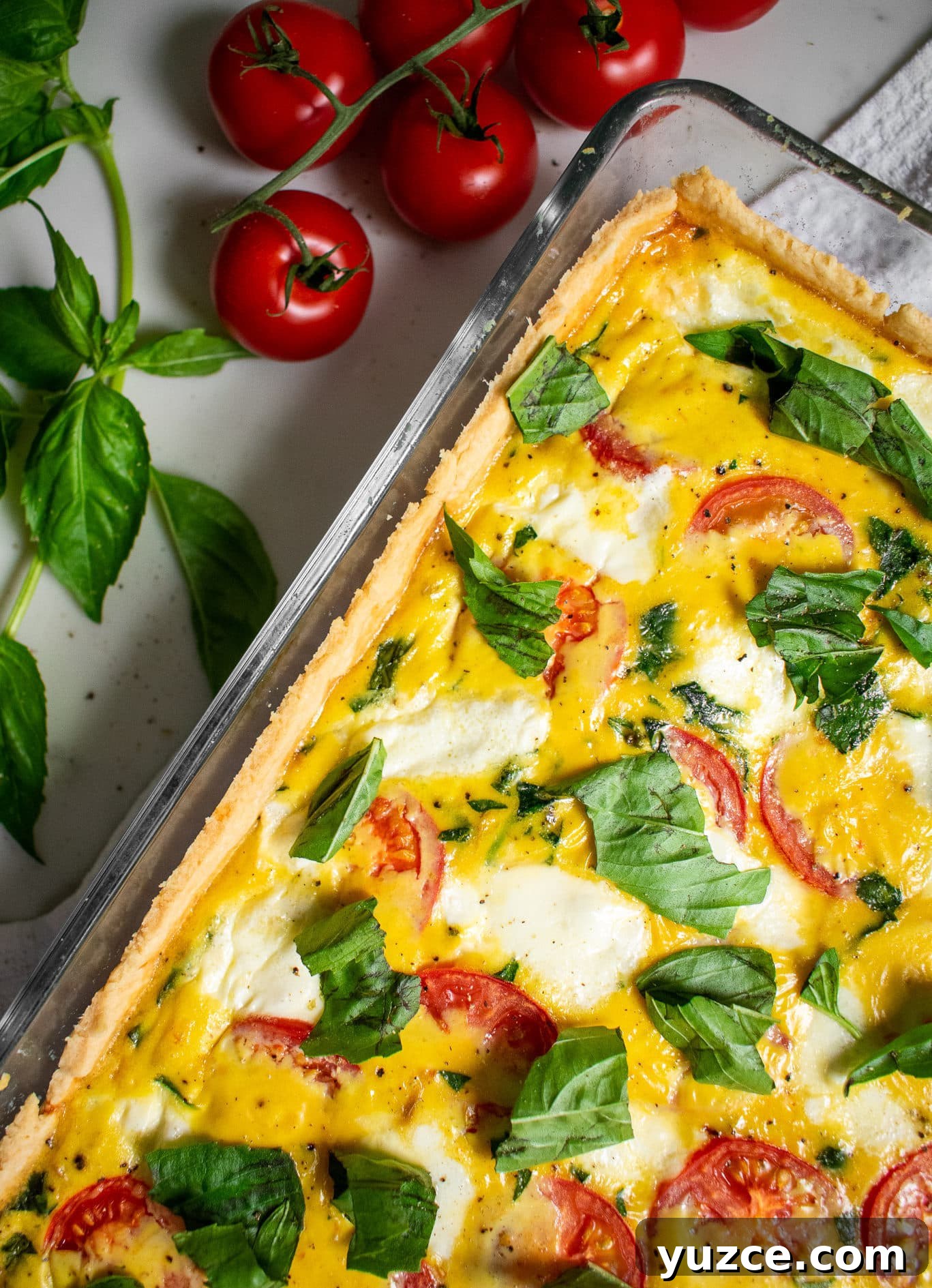 Embrace Hygge Year-Round: Cozy Living Beyond Winter 7 A quiche with basil, mozzarella, and tomato.