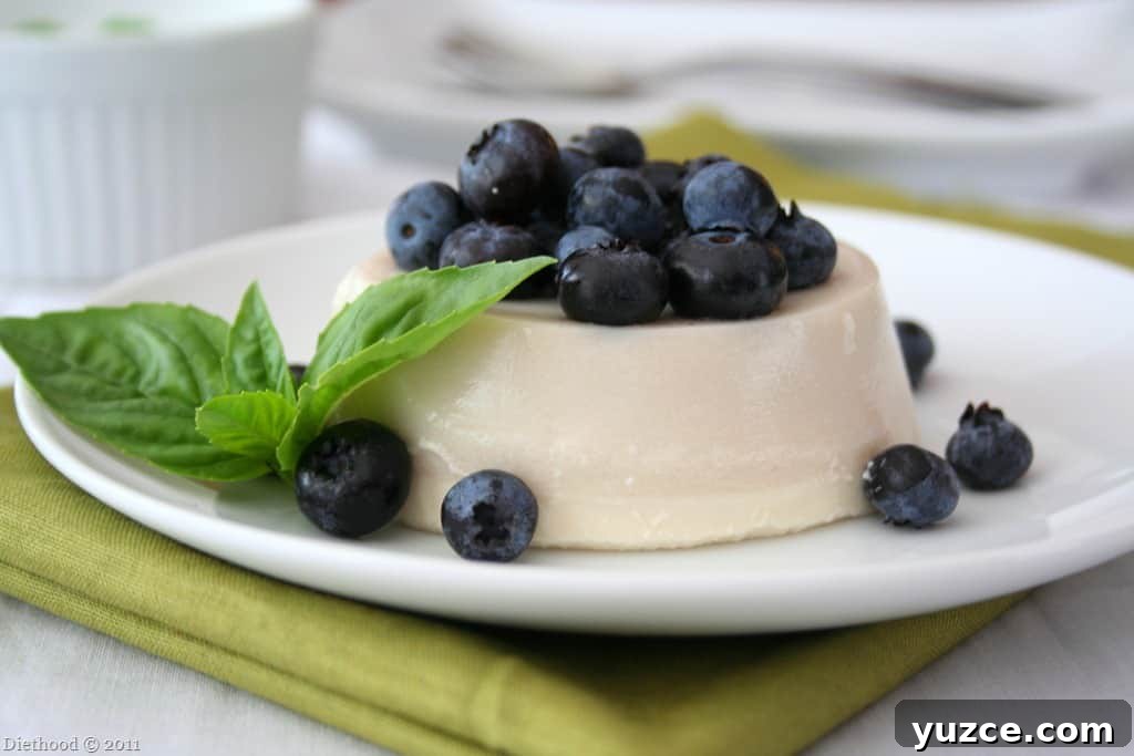 This easy panna cotta recipe is a creamy, custard-like dessert made with milk, cream, and gelatin. It's a quick, no-bake treat that’s perfect to make ahead. Panna cotta on a white plate.