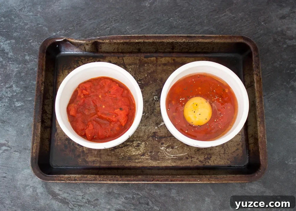 Tomato Baked Eggs with Ham Recipe: Savory One-Pan Breakfast 7 Small bowls filled with herby tomatoes and topped with eggs