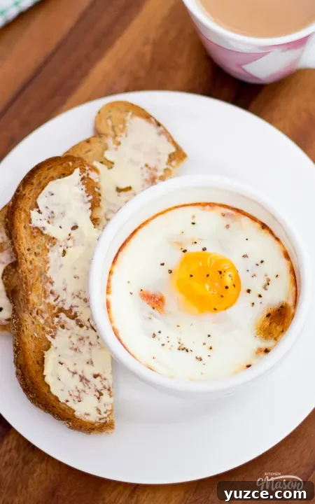 Tomato Baked Eggs with Ham Recipe: Savory One-Pan Breakfast 3 A bowl of tomato baked eggs on a plate with some toast