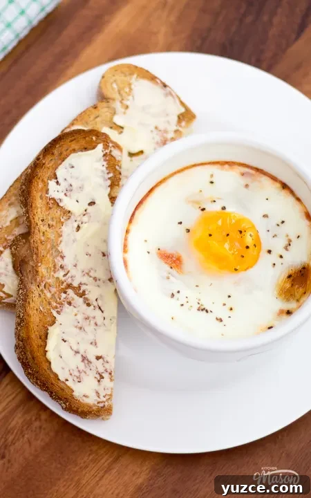 Tomato Baked Eggs with Ham Recipe: Savory One-Pan Breakfast 4 Tomato baked eggs on a plate with buttered toast