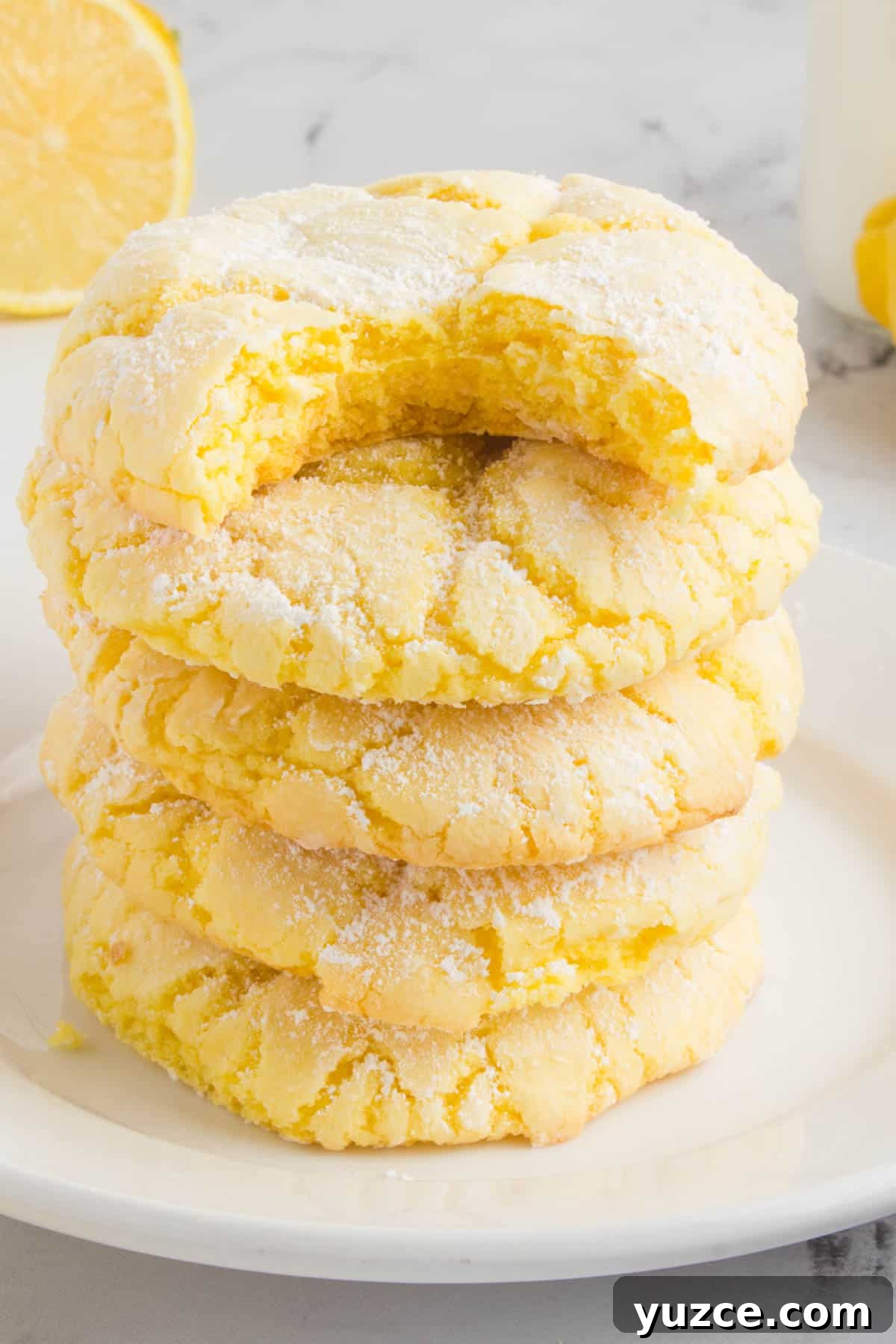 Chewy Lemon Cake Mix Cookies: Quick Citrus Cookie Recipe 2 stack of lemon cake mix cookies sitting on a white plate