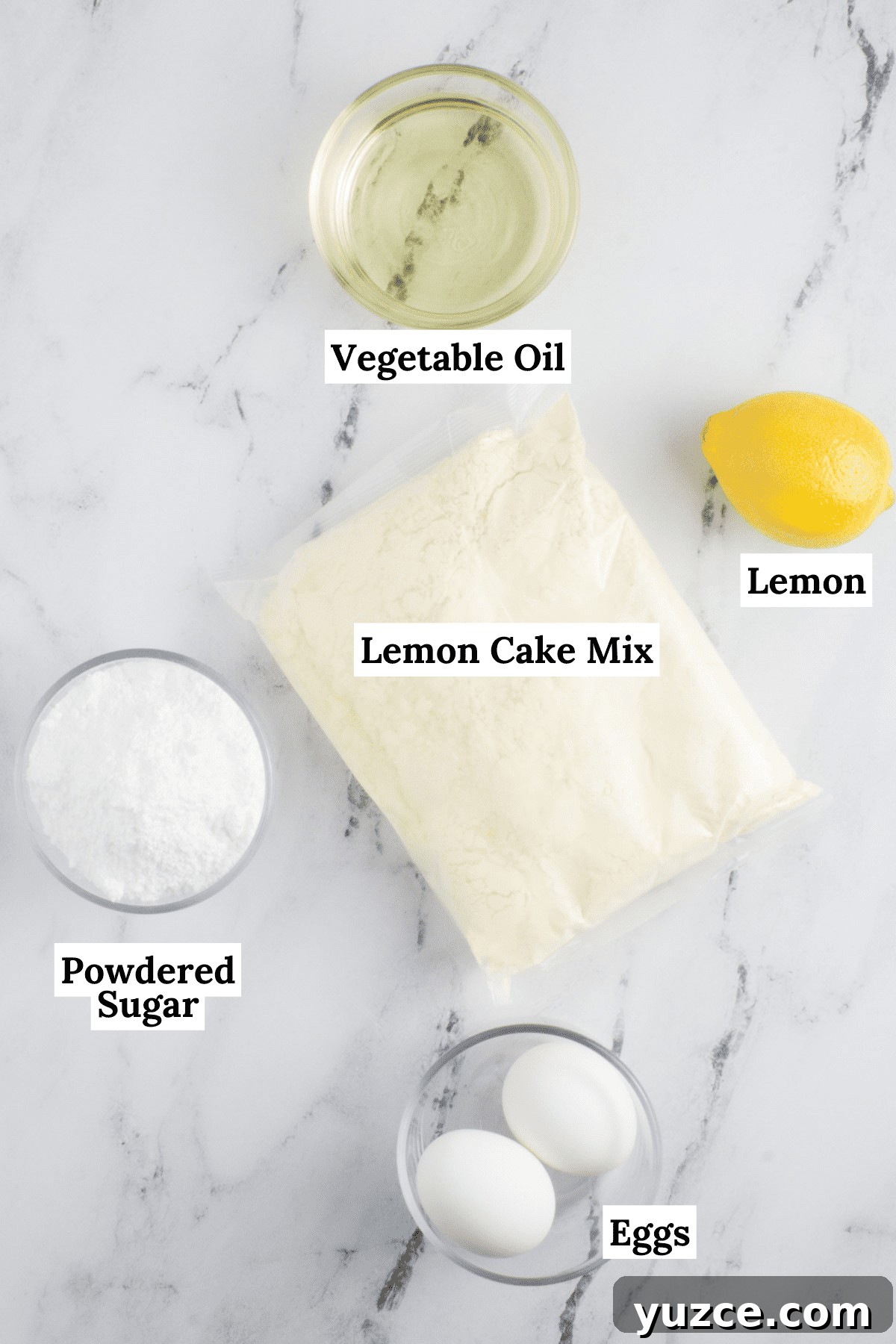 Chewy Lemon Cake Mix Cookies: Quick Citrus Cookie Recipe 4 ingredients for lemon cake mix cookies arranged on a countertop including eggs, a bag of cake mix, powdered sugar, a lemon and vegetable oil