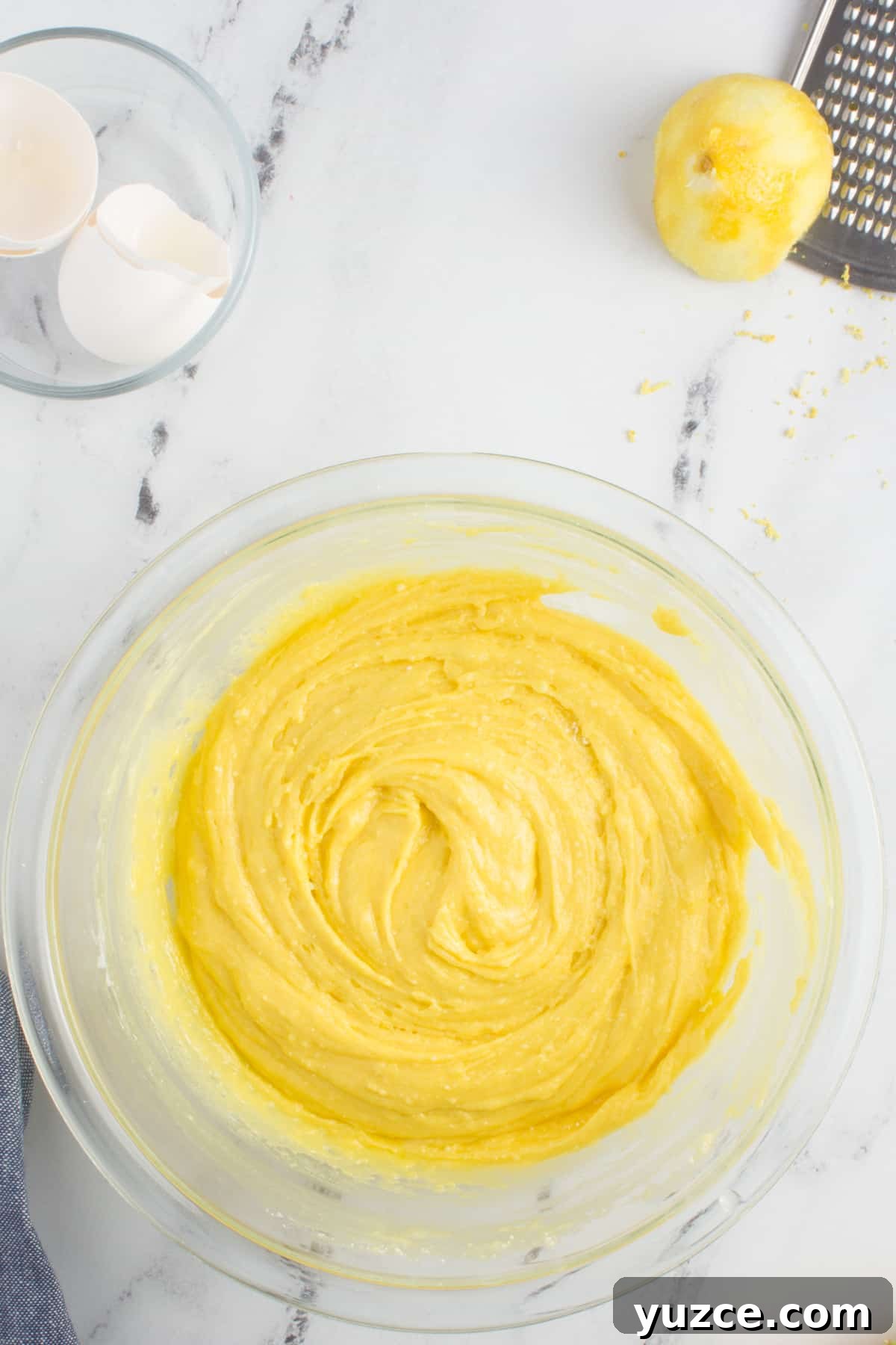 Chewy Lemon Cake Mix Cookies: Quick Citrus Cookie Recipe 6 lemon cookie cake mix dough in a glass bowl sitting on a granite counter top