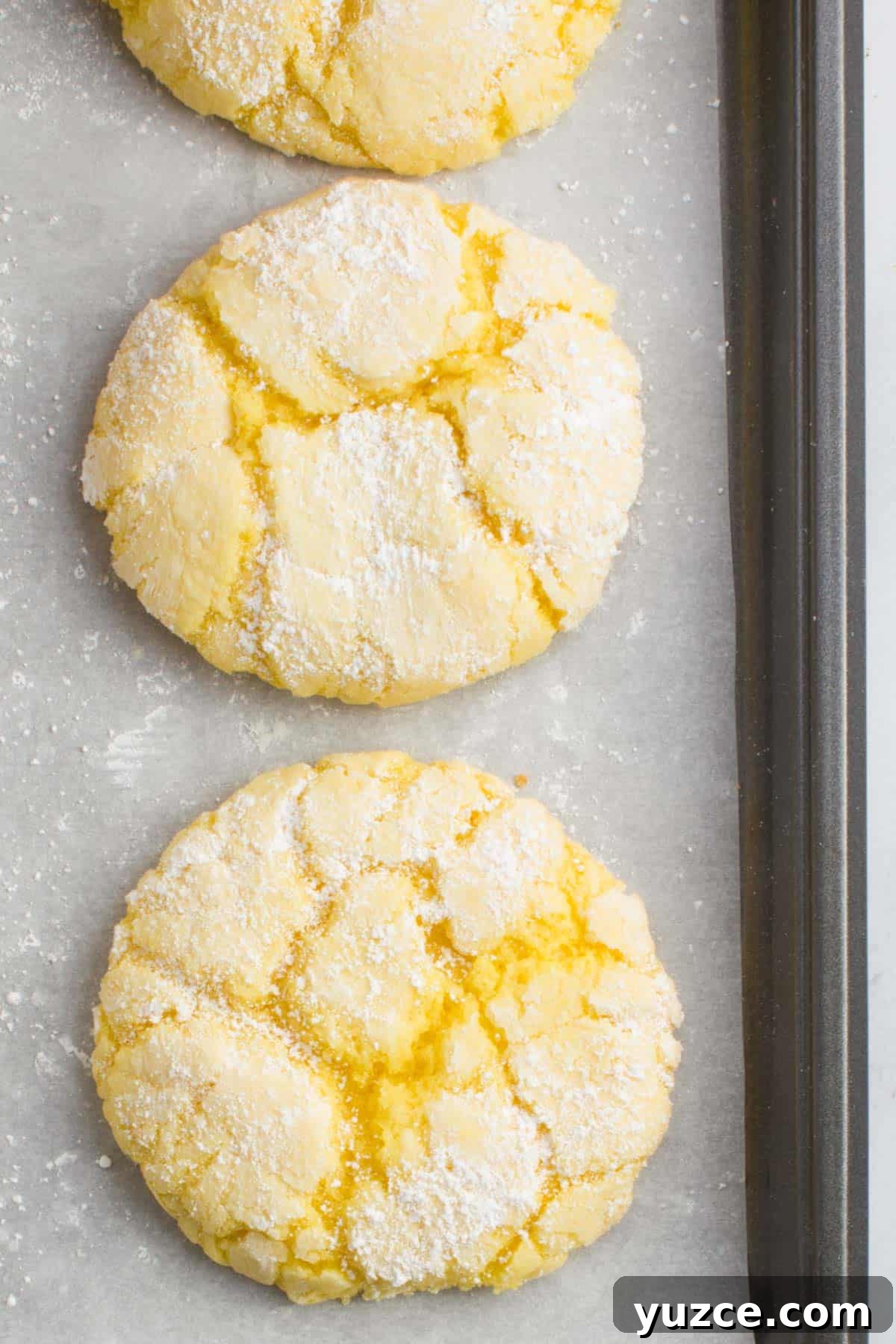 Chewy Lemon Cake Mix Cookies: Quick Citrus Cookie Recipe 10 two lemon cake mix cookies on a baking sheet lined with parchment paper