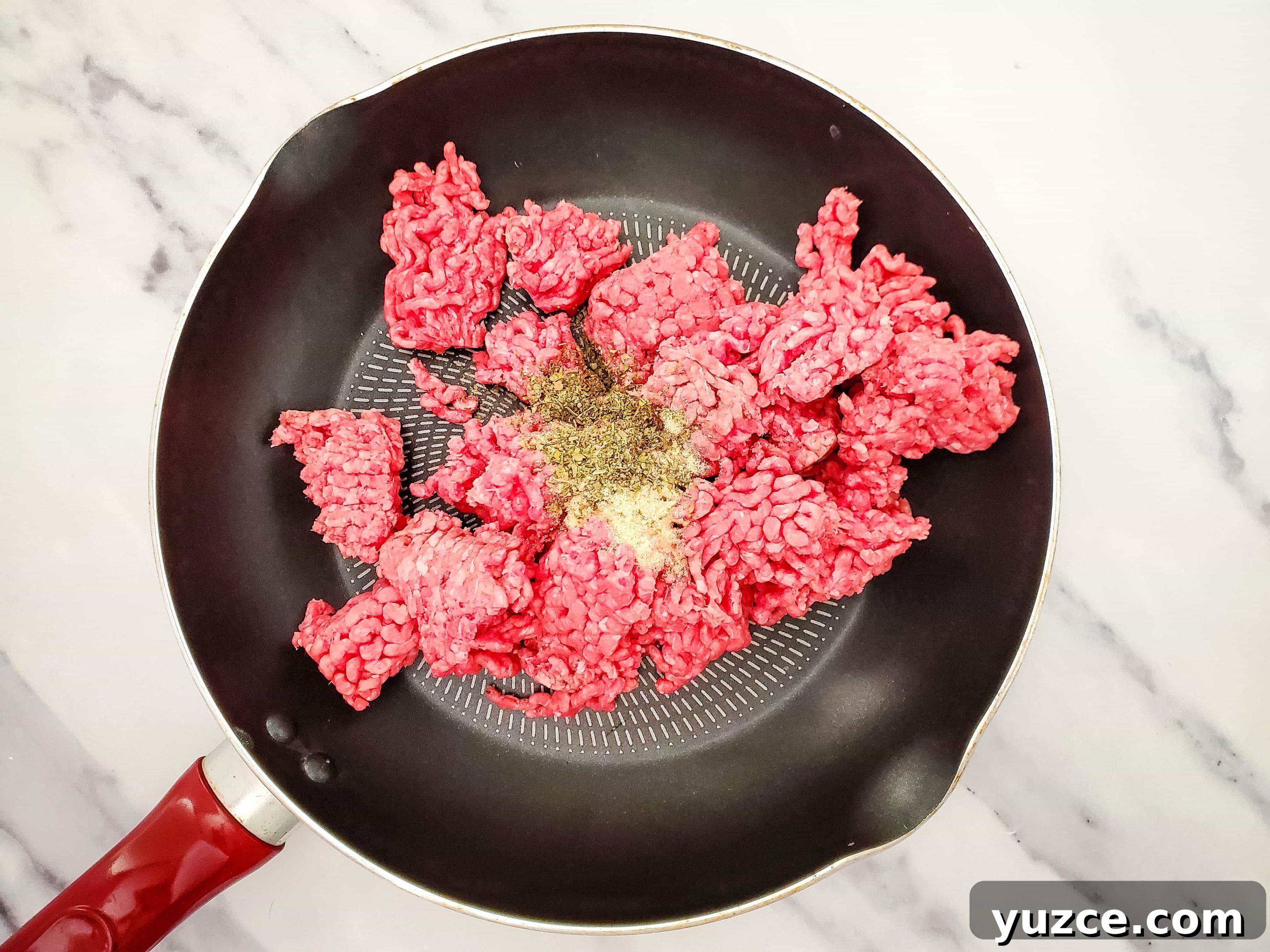 Quick Ravioli Lasagna Recipe for Busy Weeknight Dinners 3 Photo of cooking skillet with raw ground beef and spices.