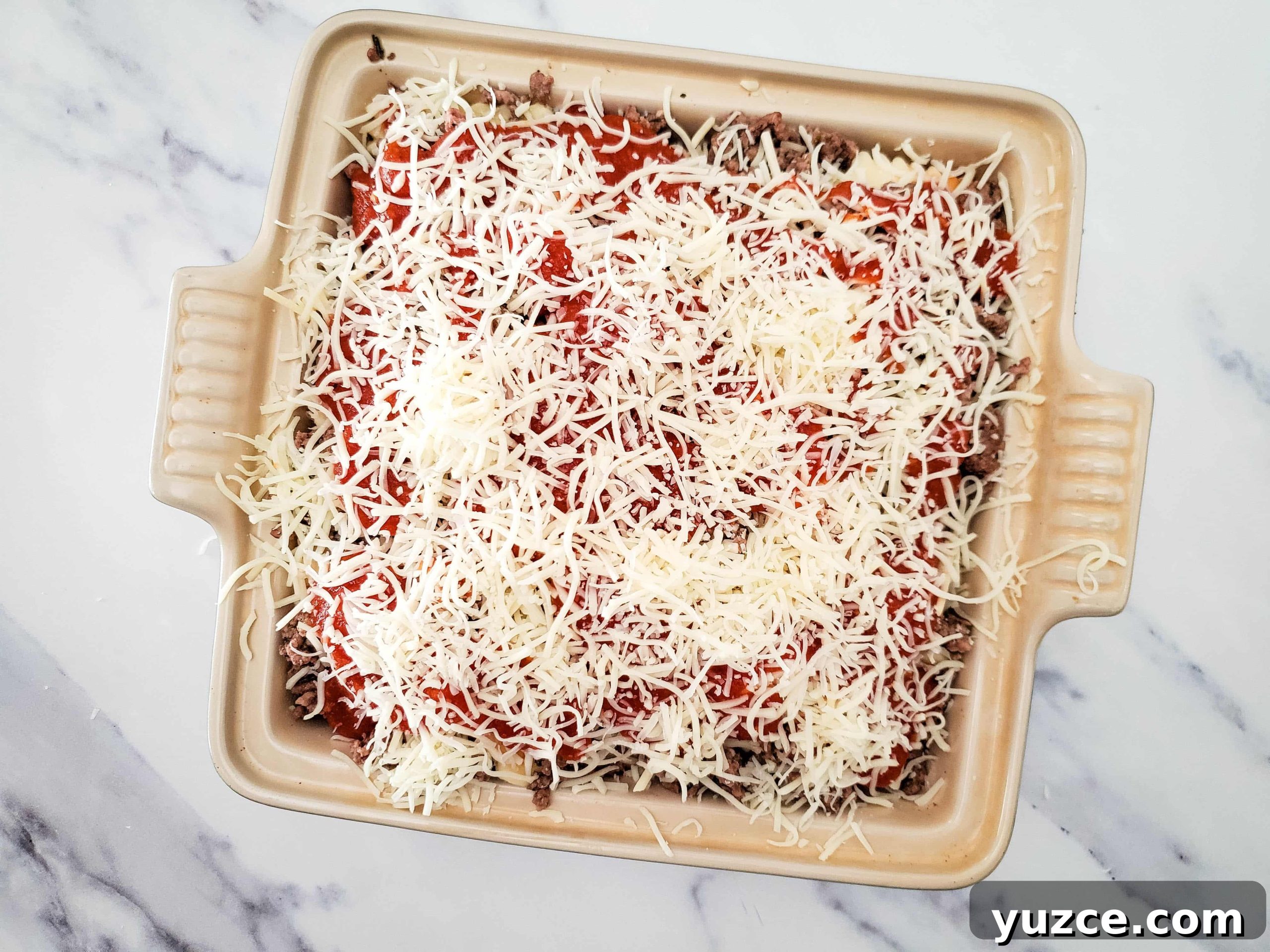 Quick Ravioli Lasagna Recipe for Busy Weeknight Dinners 9 Casserole baking dish with layers of frozen ravioli lasagna