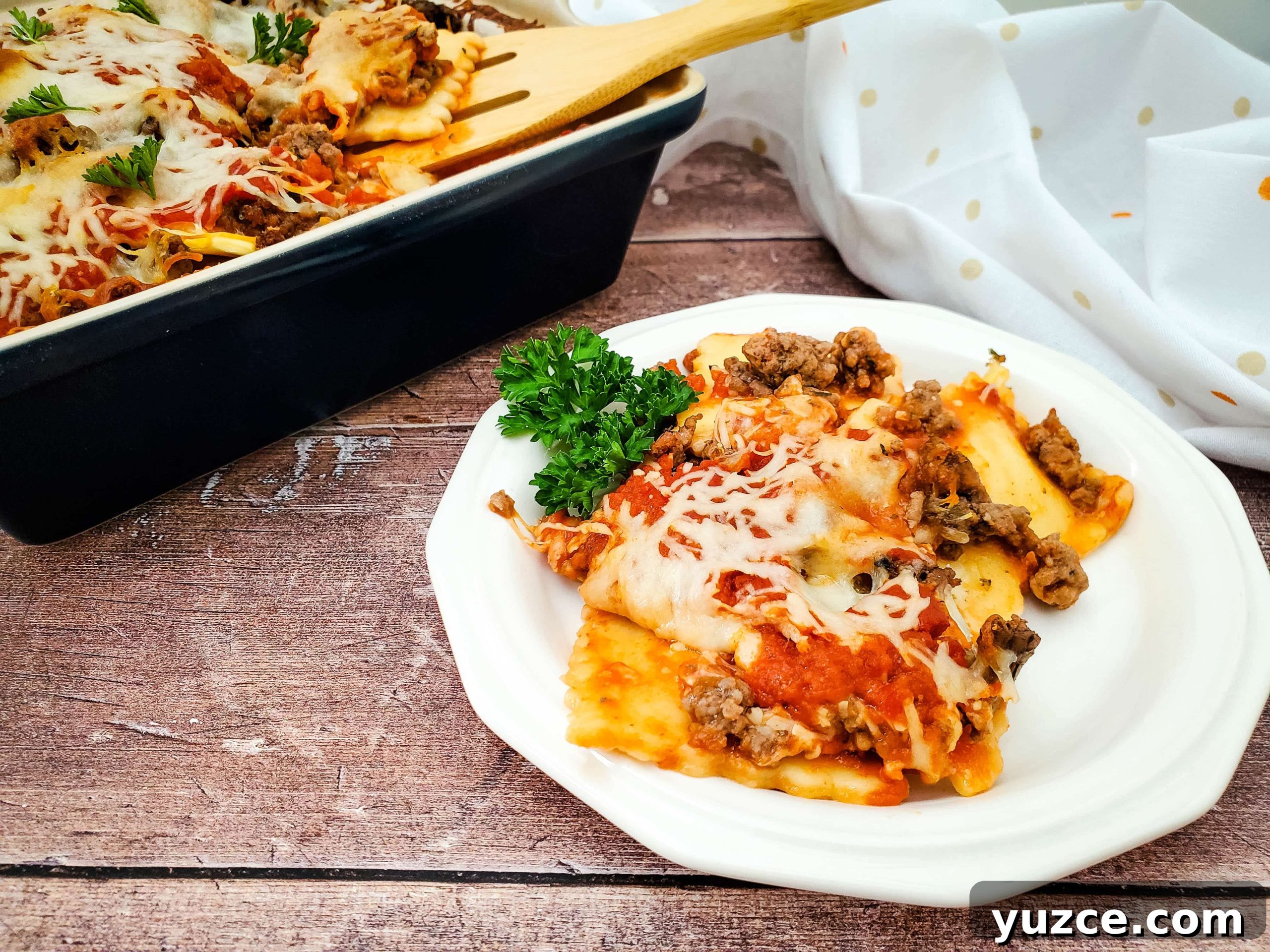 Quick Ravioli Lasagna Recipe for Busy Weeknight Dinners 10 Image of finished frozen ravioli lasagna plated on white dish.