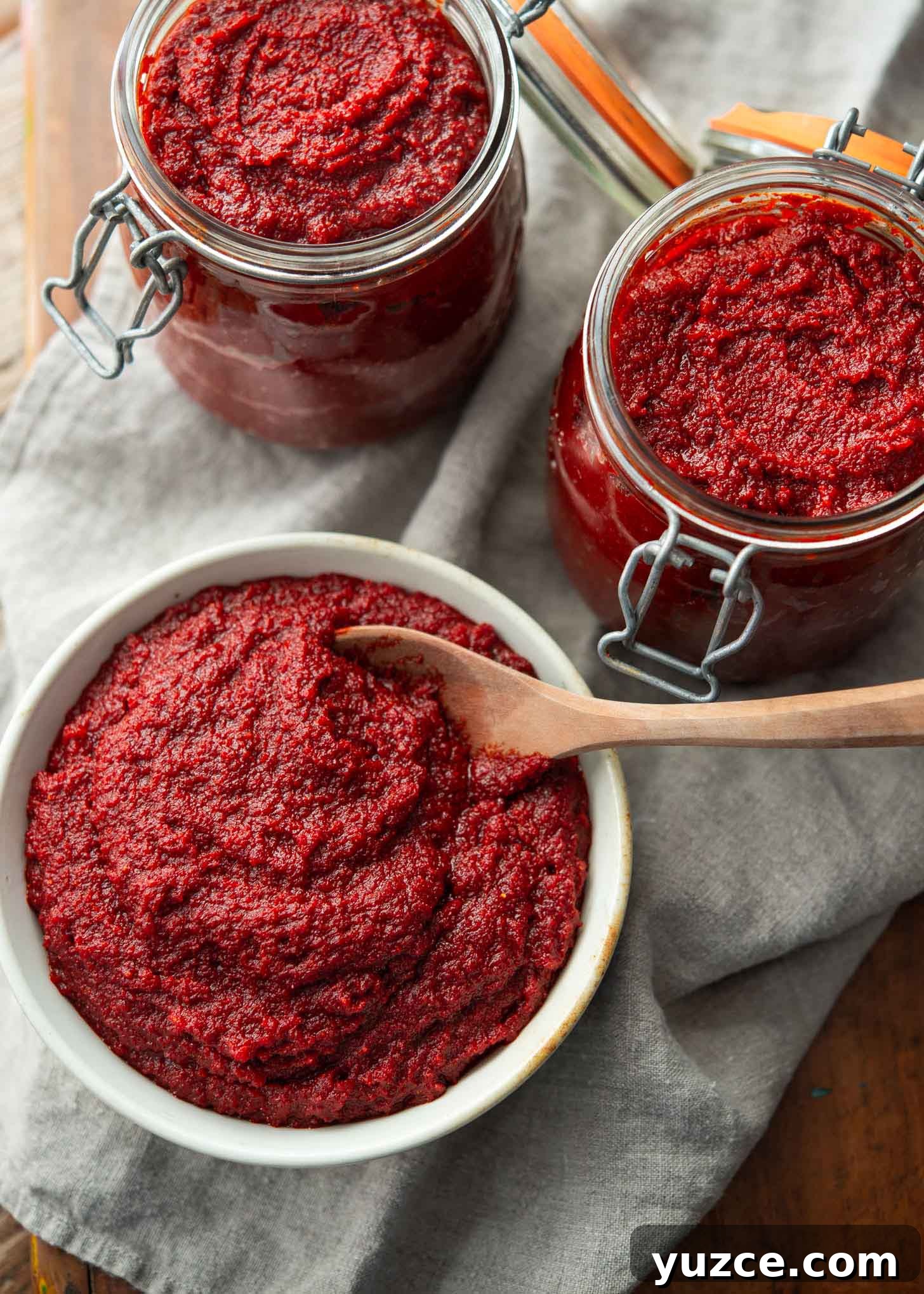 Quick 10-Minute Homemade Gochujang Recipe 14 Korean chili paste in a bowl and glass jars.